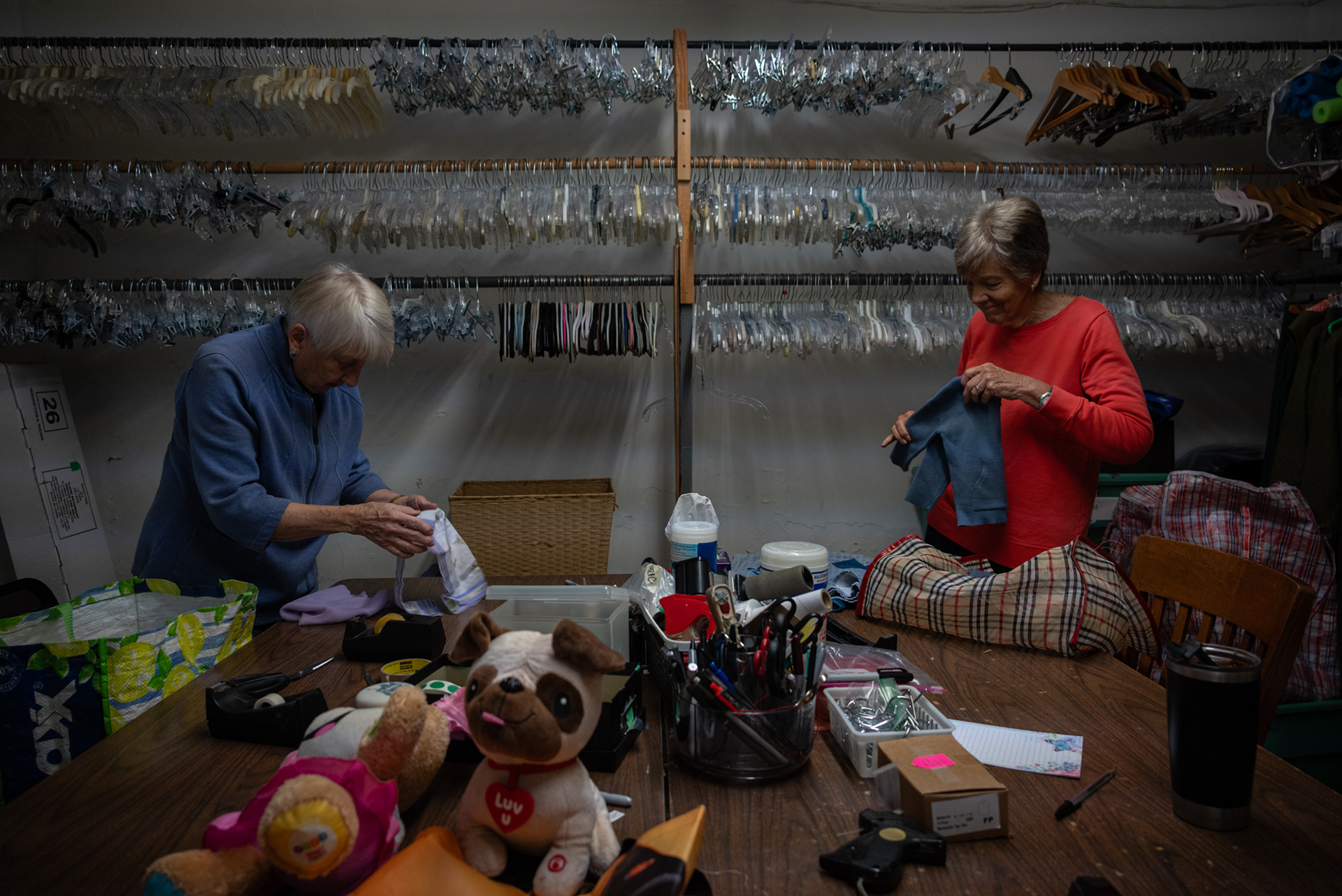 Volunteers Suzanne Beatty and Laura Bigness sort and tag new donations.  All items are first checked for quality before they are sold and are mended or fixed if needed. For items that cannot be sold, the store donates the materials to make sure nothing is wasted.  