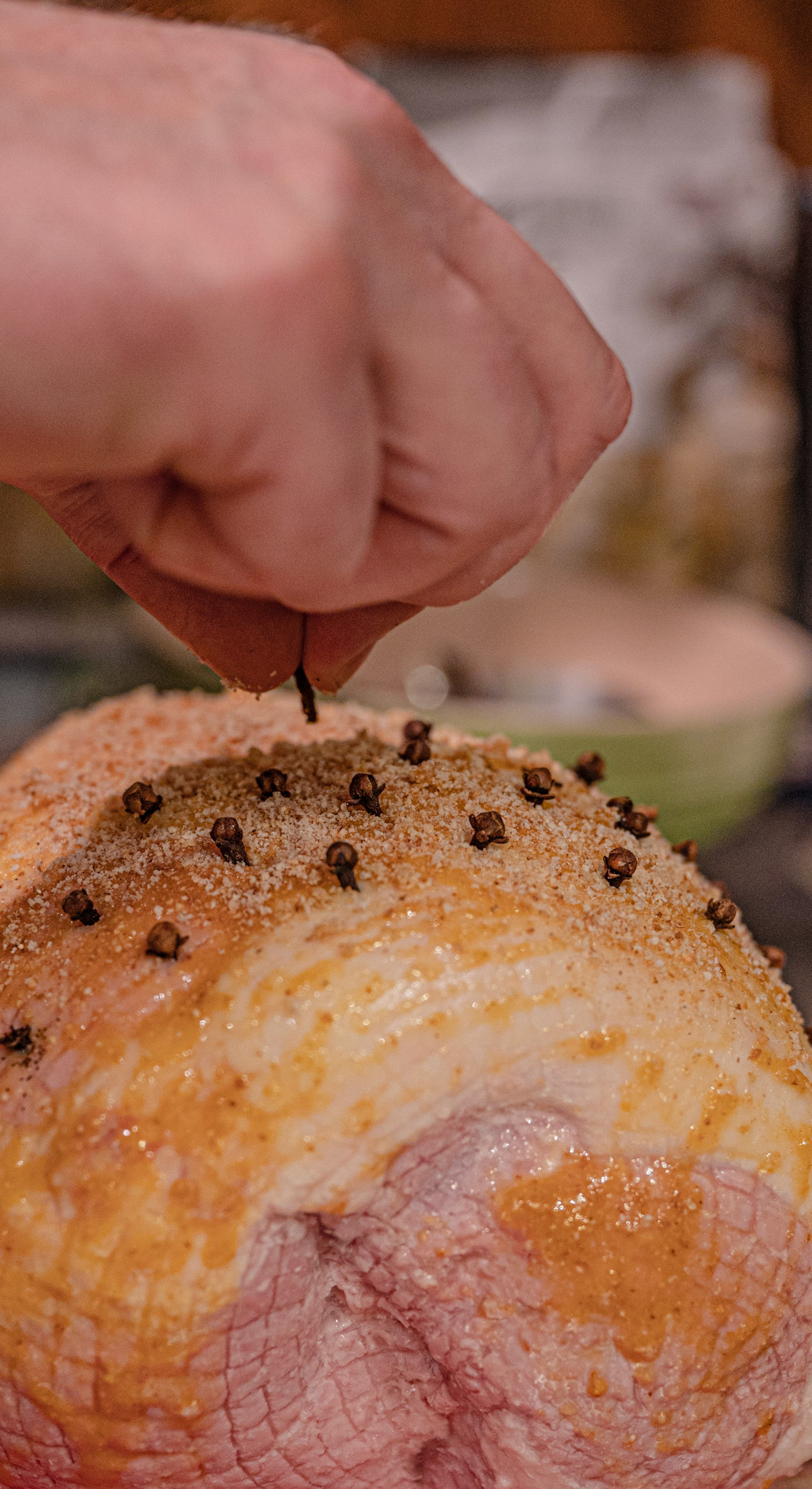 Erik prepared the julskinka (Christmas ham) coated with mustard, breadcrumbs, and cloves.