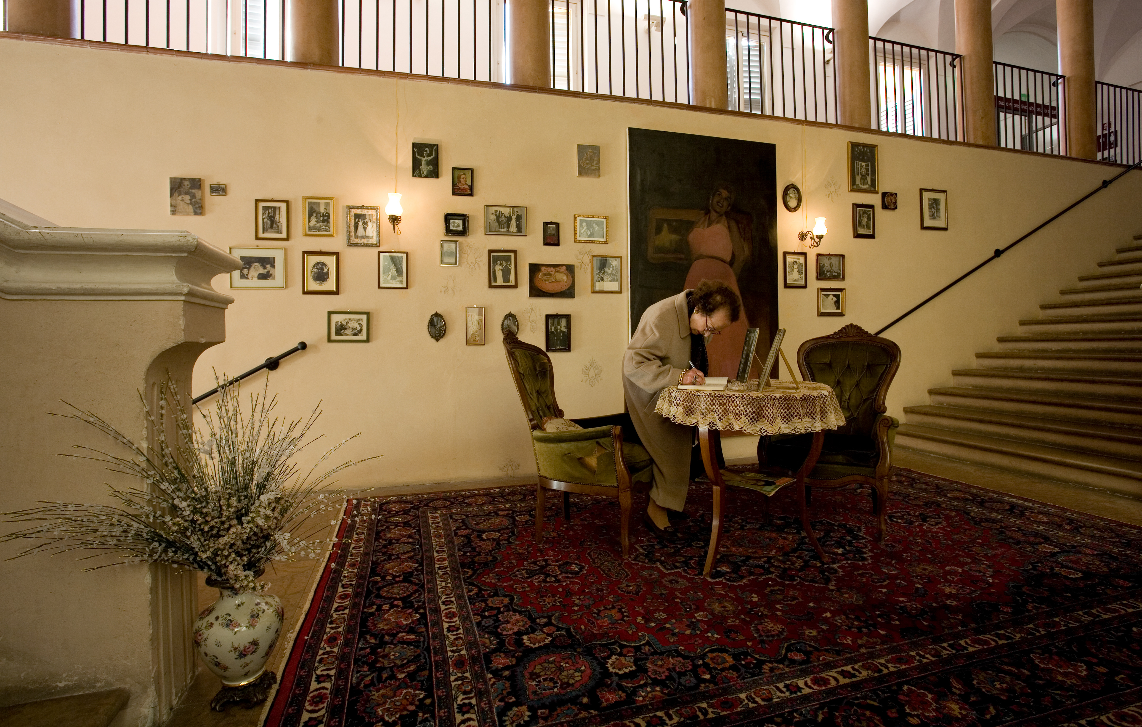 View of the installation with a woman signing the guest book