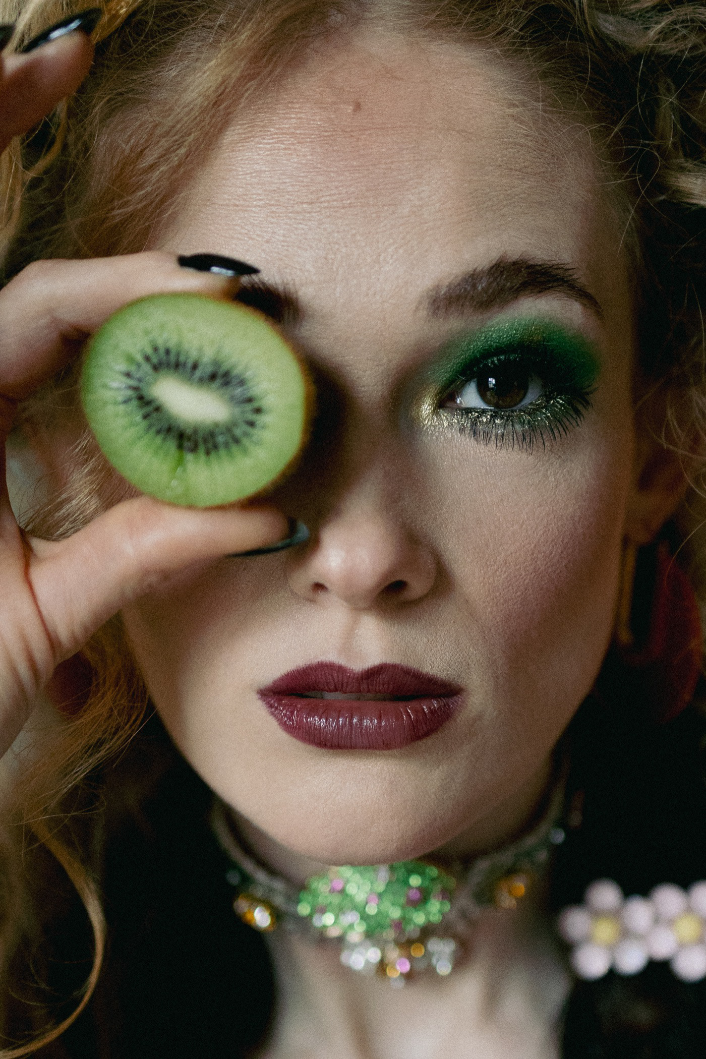 Sasha Sytenko — beauty portrait with green eye make-up and kiwi.