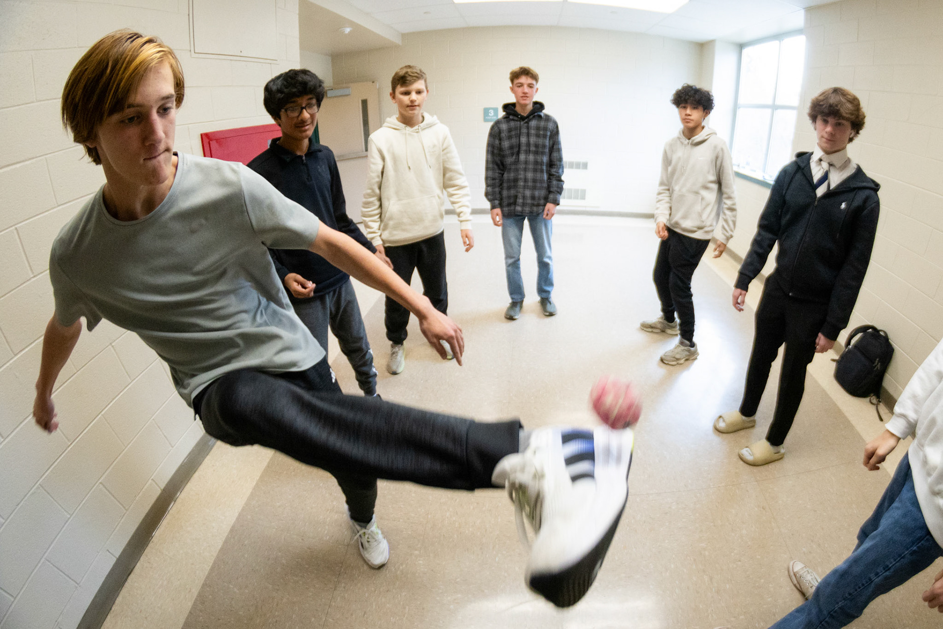 A group of hacky sackers overwhelm the hallways on Dec. 11