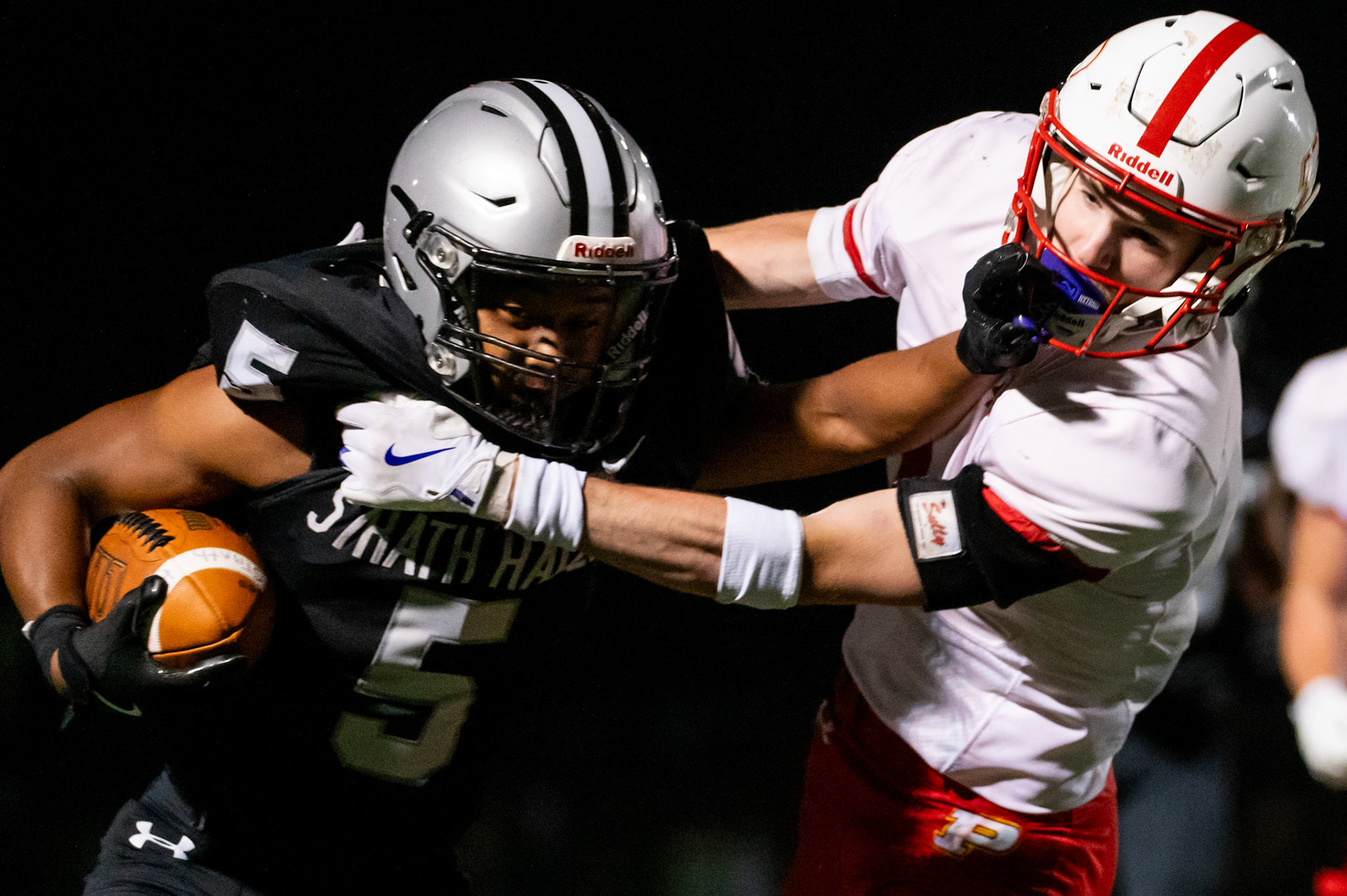Kasey Hudson '27 carries the ball as he protects himself in defense, rushing to a touchdown on Aug. 28, 2025.