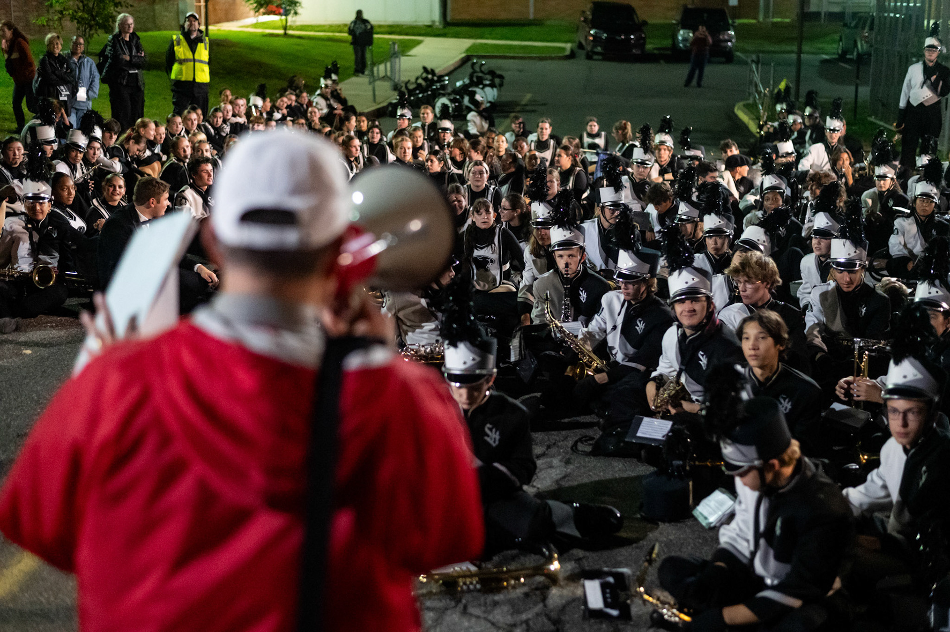 The Marching band listens in on a performance judge on Oct. 11.