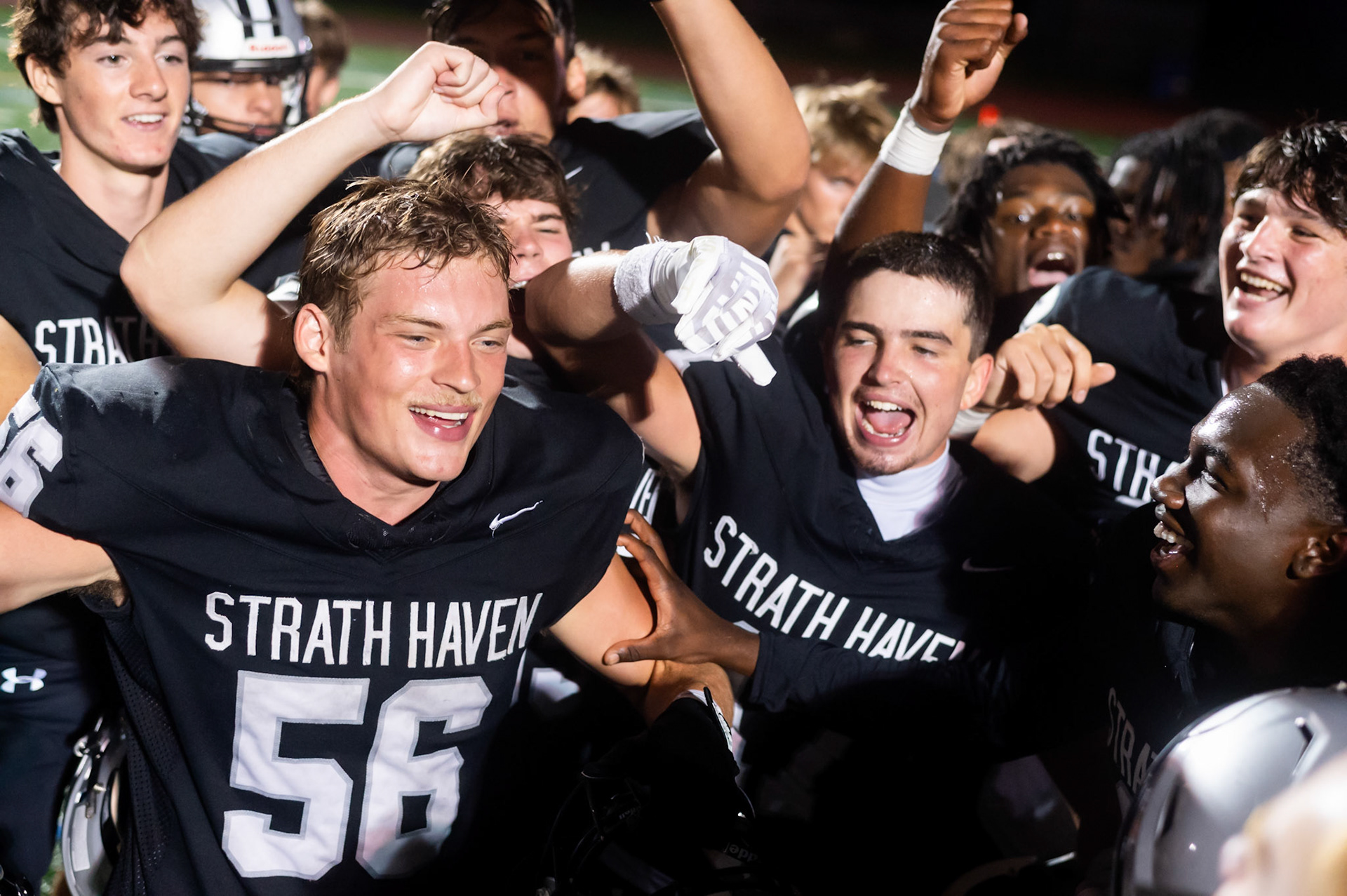Nicholas Farabough '26 and Quinn Kell '26 celebrate with the football team after a victory Friday night on Aug. 22, 2025.