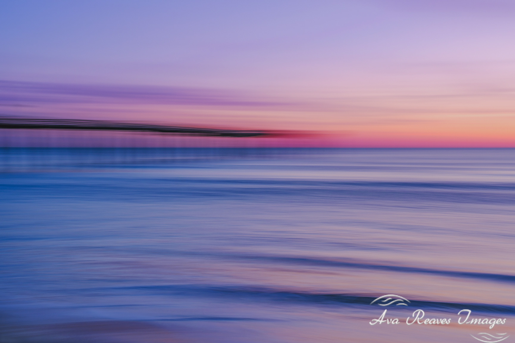 Dreamy sunrise seascape of Virginia Beach Fishing Pier using ICM technique, with colorful sky and blurred waves