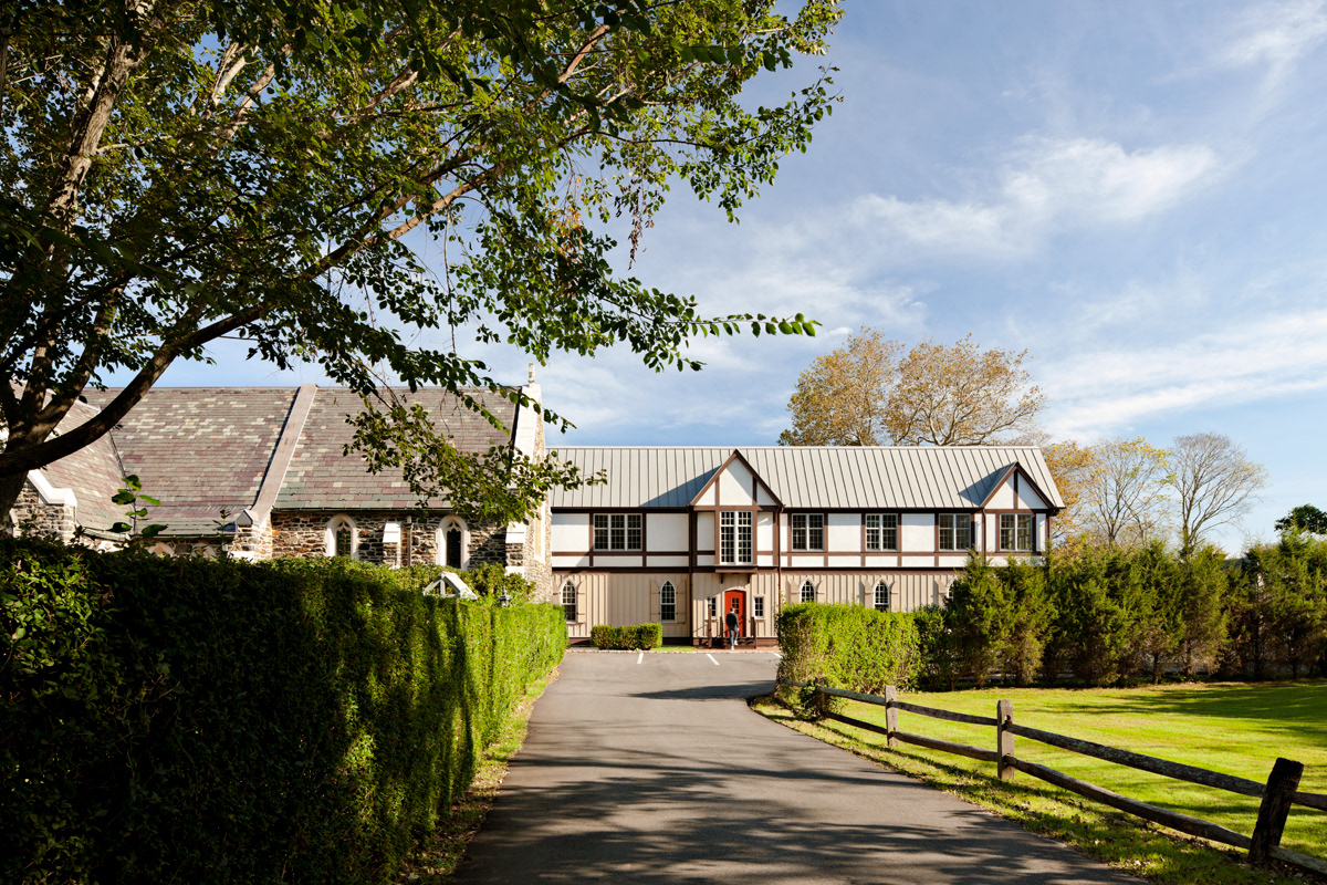 Parish Hall exterior, with half timbering, board and batten siding and metal roof.