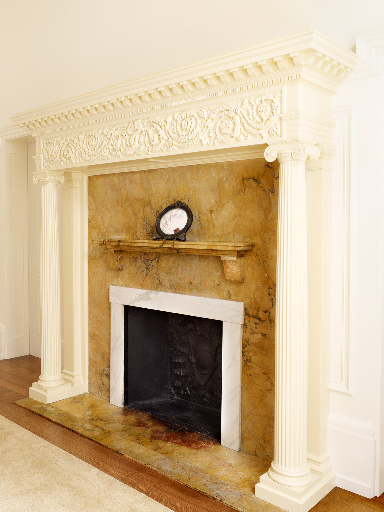 Restored fireplace mantel with new ionic columns.