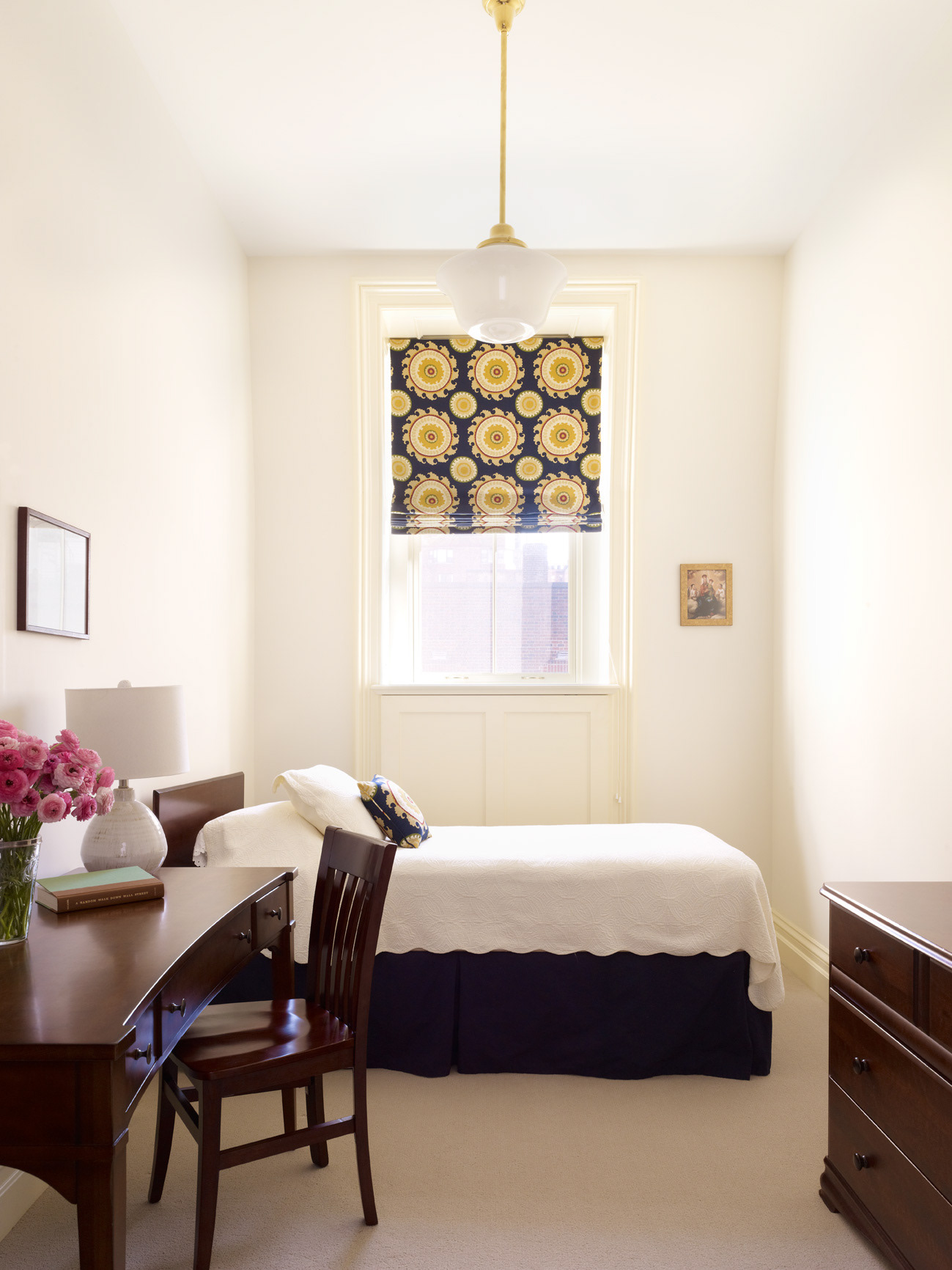 Bedroom with blue roman shade and classic schoolhouse pendant light.