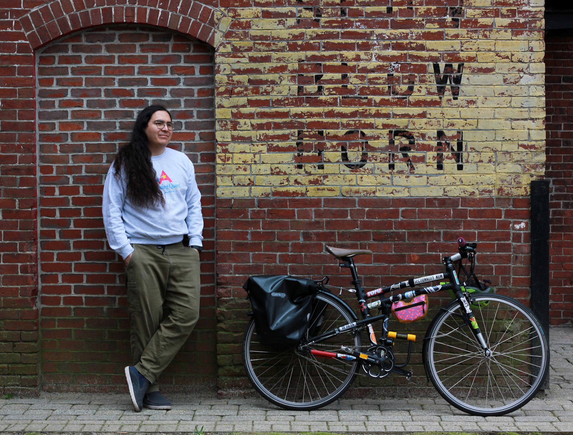 Alex, They/Them . “I have always been in-between as a person, whether that is ethnicity, race, or gender. Not 50% this and 50% that but 100% a third, unique thing; the insider with an outside perspective. I was really lucky to grow up in Los Angeles where in-between-ness isn’t too uncommon and I could really explore my identity. It’s a real privilege that I was able to have a community that gave me the experience to look at the world as a gradient not a binary.  I’ve been in Maine for over a decade but I am new-ish to Lewiston. I joke that I just moved here to say that I moved from one LA to another. When I came to Lewiston, I thought about the issues and identities that are important to me and which ones would make the most sense to engage with. There are so many wonderful queer people in the area but there is a lack of spaces for us to gather and build community. I ended up taking on running an existing social event called Second Saturday and with some friends we’ve built L-A It’s Happening Queer @itshappeningqueer to organize that event and others. I’ve also helped organize Pride in Lewiston for the past couple of years and this year will be my biggest yet. We are going to have a whole week of events from June 1st to June 8th. I am really looking forward to it.  If you find yourself in Lewiston, get in touch: I wouldn’t mind showing you the city I love.”