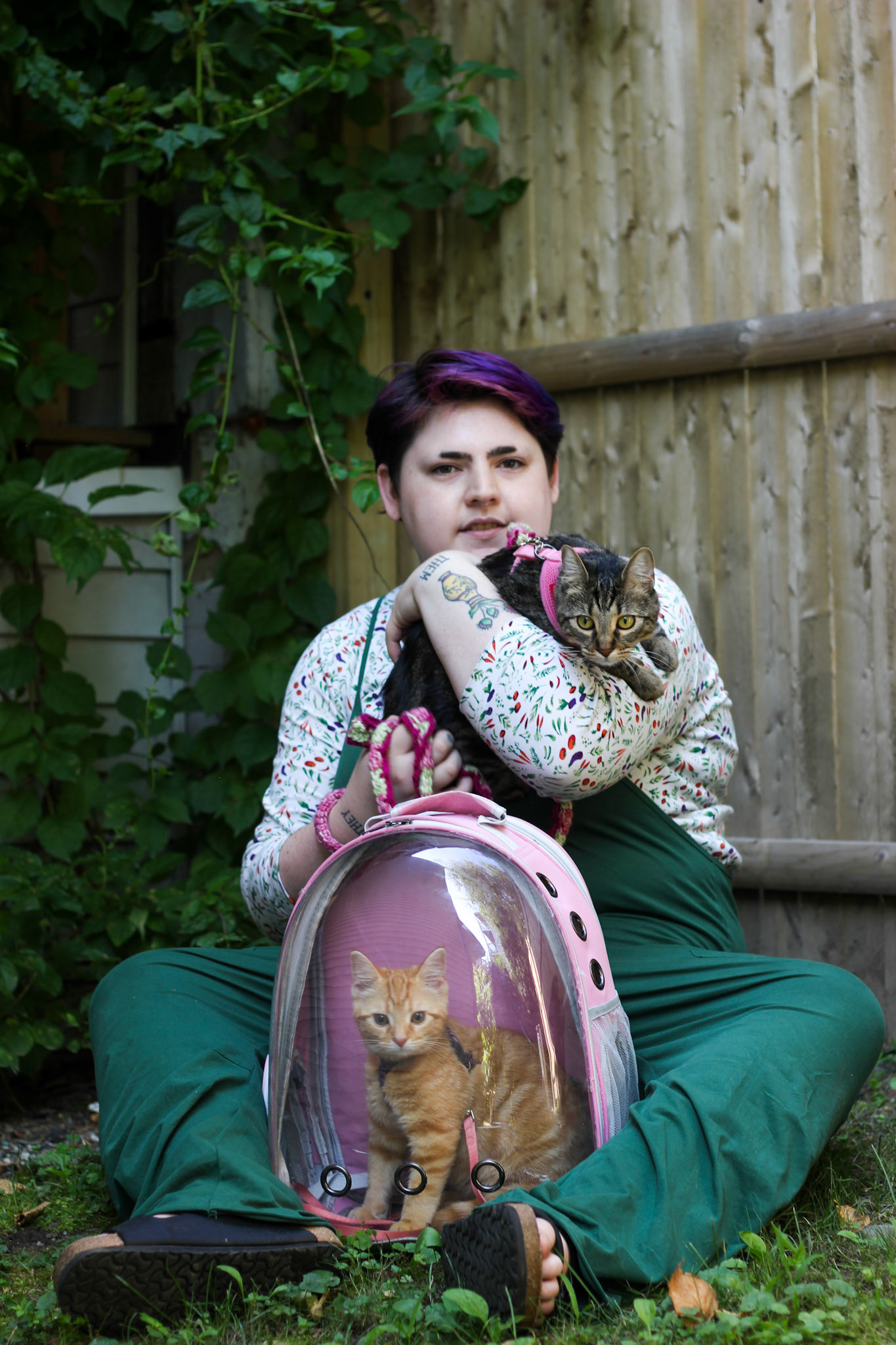 Roenick, They/Them. "Hi all! My name is Roenick, most call me Roe. I use They/Them/His pronouns and these are my kitties! Blanket (brown tabby) and Brisket (orange tabby) @blanketnbrisket. I live here in portland and go to school at MECA and have for 4 years now. You can find some of my work @roesbud_studio on instagram. I am excited to exist in such a queer friendly city and to meet such lovely queer souls,, it’s just so delightful. I have had the opportunity to sell at queer makers markets in congress square and everyone I have met there has been marvelous. Especially other vendors, making those connections is so beautiful and fulfilling every single time. Alas!"