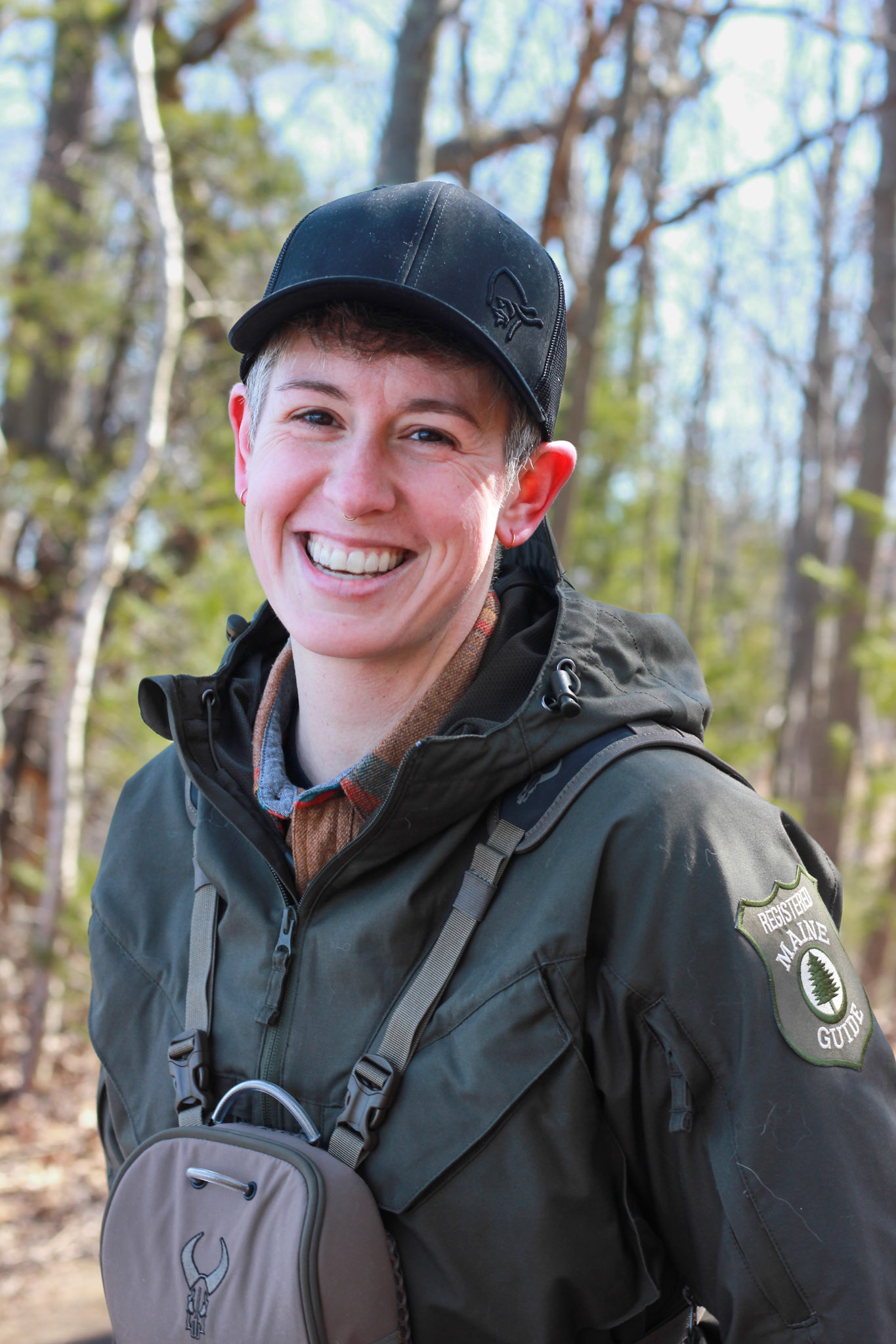 Ari, She/Her . “My name is Ari Leach and I am a second generation registered Maine Guide. I grew up on the coast of Maine in Blue Hill and attended Unity College for both my undergrad and graduate degrees. I hold a BS in Wildlife Biology with a minor in Botany, and an MPS in Sustainable Natural Resource Management, completing my thesis on the softshell clam and marine bait worm conflict dynamic here in Maine. I have been deeply connected to the outdoors and nature since childhood and have continued to seek out ways to engage with my surroundings and share my passions with others. When I'm not working as a marine biologist for the state of Maine or wearing my Maine Guide hat, you can find me with my eyes glued to the skies in search of birds, on my mountain bike trying out new trails, or on the water wetting a line in hopes of a wild fish fight. I love any activity that gets me outside and closer to nature. I am also passionate about wilderness survival and ancestral skills, maintaining a wilderness first responder certification for over a decade. My hope is that I can impart a bit of knowledge, curiosity, and sense of adventure to those who join me in the wild, creating space to explore and ask questions in a safe and encouraging setting. Nature is for all, and we are all of nature.”