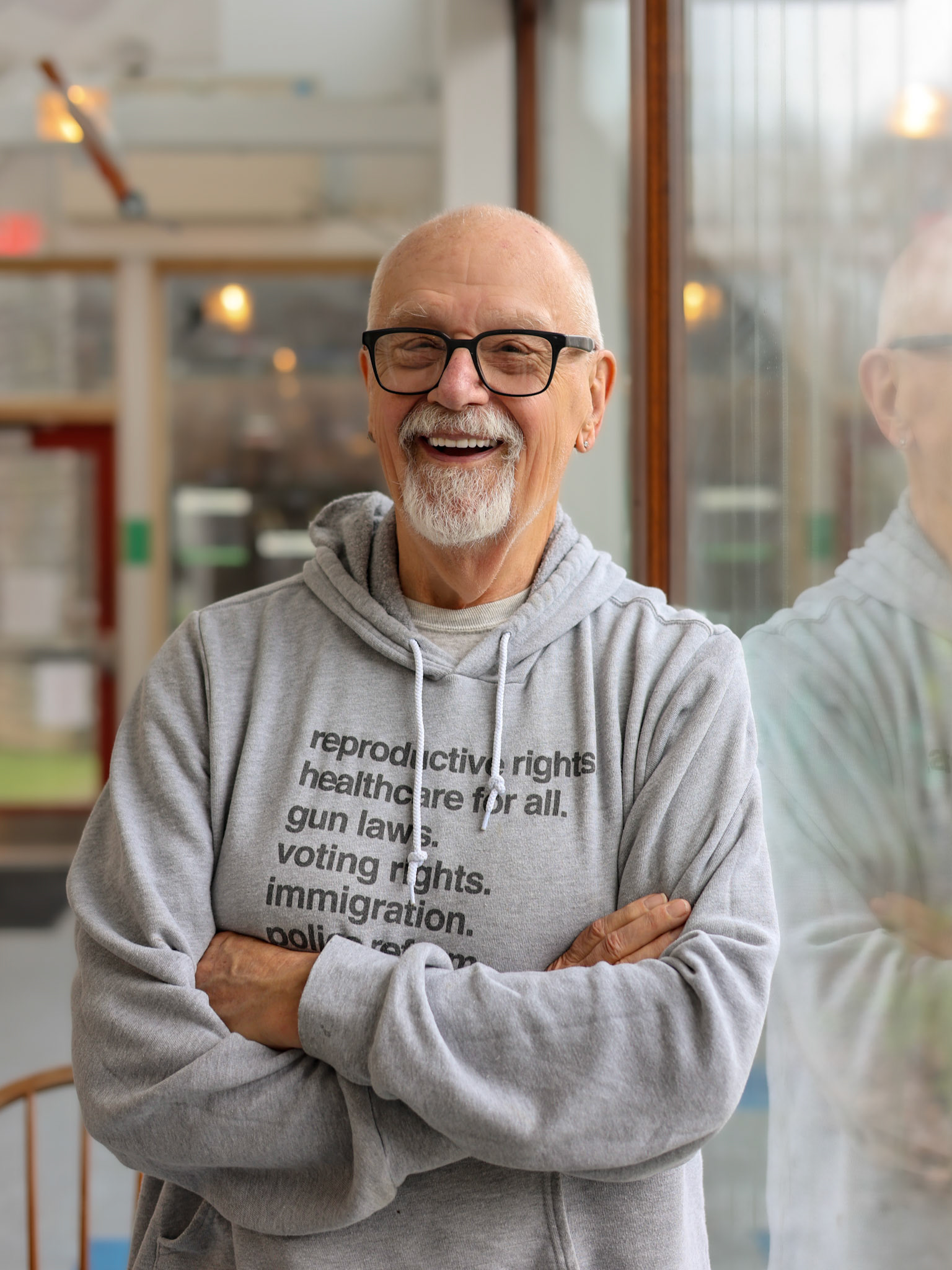Skip, He/Him . “Skip Brushaber has been active in the LGBTQ and recovery communities for many years. He is one of the founding members of AIDS Project and the Our Paper Collective. For many years, Skip was on the board of the Westbrook Food Pantry and volunteers at the Animal Refuge League. He also is a greeter at the Equality Community Center and actively participates in activities through the Network for Older Adults. A published writer and mixed media artist, Skip is committed to human rights and social change through his art. He resides in Westbrook with his three four legged friends who rescued him.”