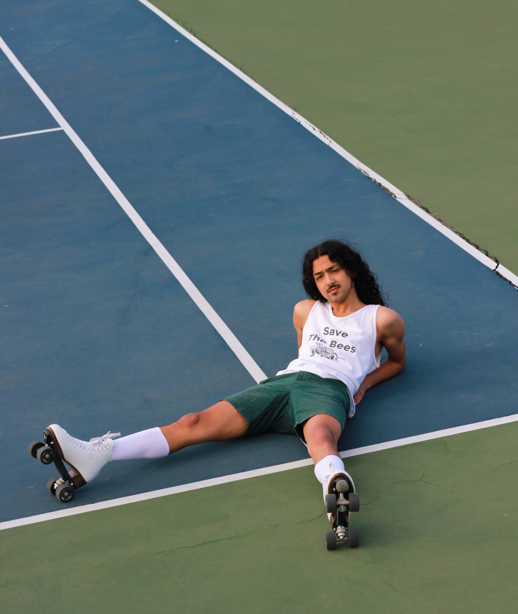 Topher, He/Him . “I'm out here chasing bliss, wondering all the while if here is where I’m meant to be. Sure, people have greeted me with open arms, a seat at the table and communities have become family, but what can I offer beyond what I consume and produce? Is the care I offer to this new land, to the people who were here before me enough? Am I giving to the culture here or only a gluttonous consumer and gentrifier? Many Mainers are all too familiar with the practice of discouraging outsiders from calling this place home: from the Irish, to the French Canadian, to the most recent Somali communities. Despite holding identities outside these communities, I still find myself inhabiting a body that does not look like your ""typical Mainer"". I grew up in LA (Los Angeles not Lewiston-Auburn) and moved here to get an education only to fall in love with the land. I felt claustrophobic at first, constantly bombarded with whiteness, but I like to think I've found the confidence to show up fully and make space for those on the fringes. It's a lot better than thinking I've just grown numb to it all. Bliss is what I find when I get on those 8 wheels. Wind billowing through my hair and earrings jangling along to the mellifluous melodies merrily playing through my phone. Childlike discoveries are made with every spin, fall, and jump. And, I find that this is exactly where I'm meant to be.”