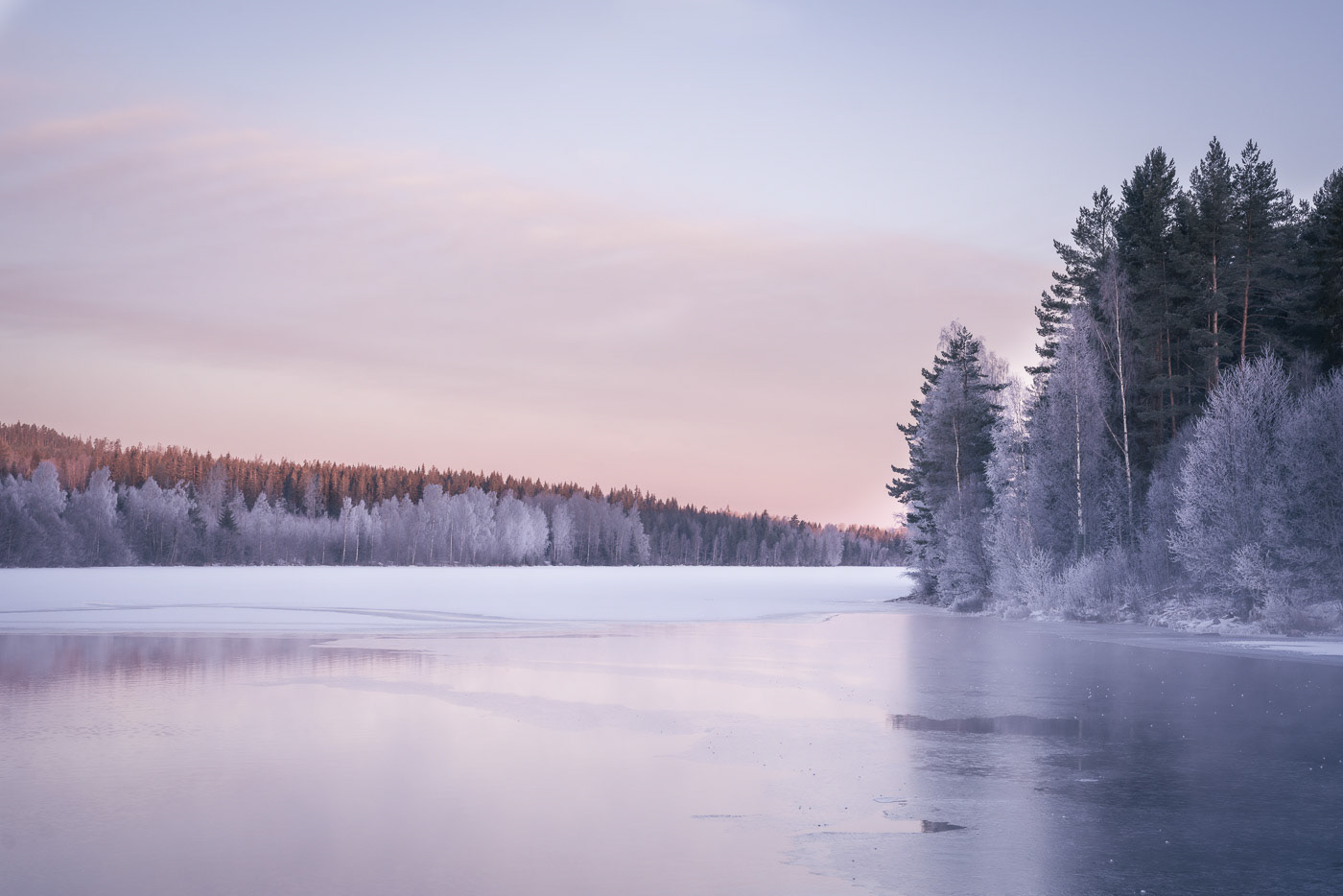 Sweden - Winter landscape with frozen lake surrounded by the forest