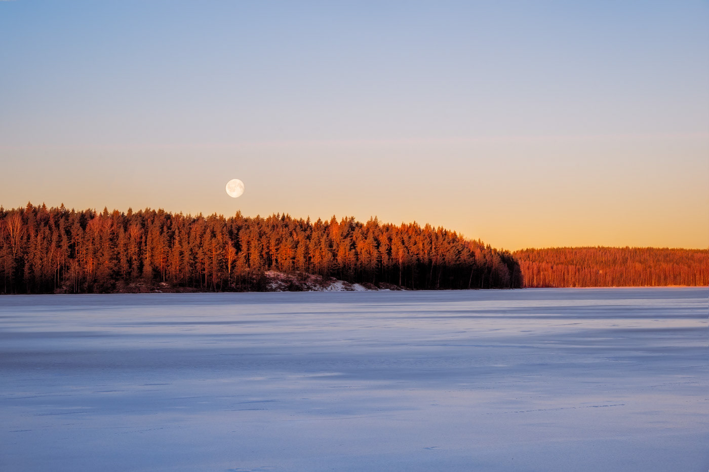 Sweden - Dawn moonlit over frozen lake