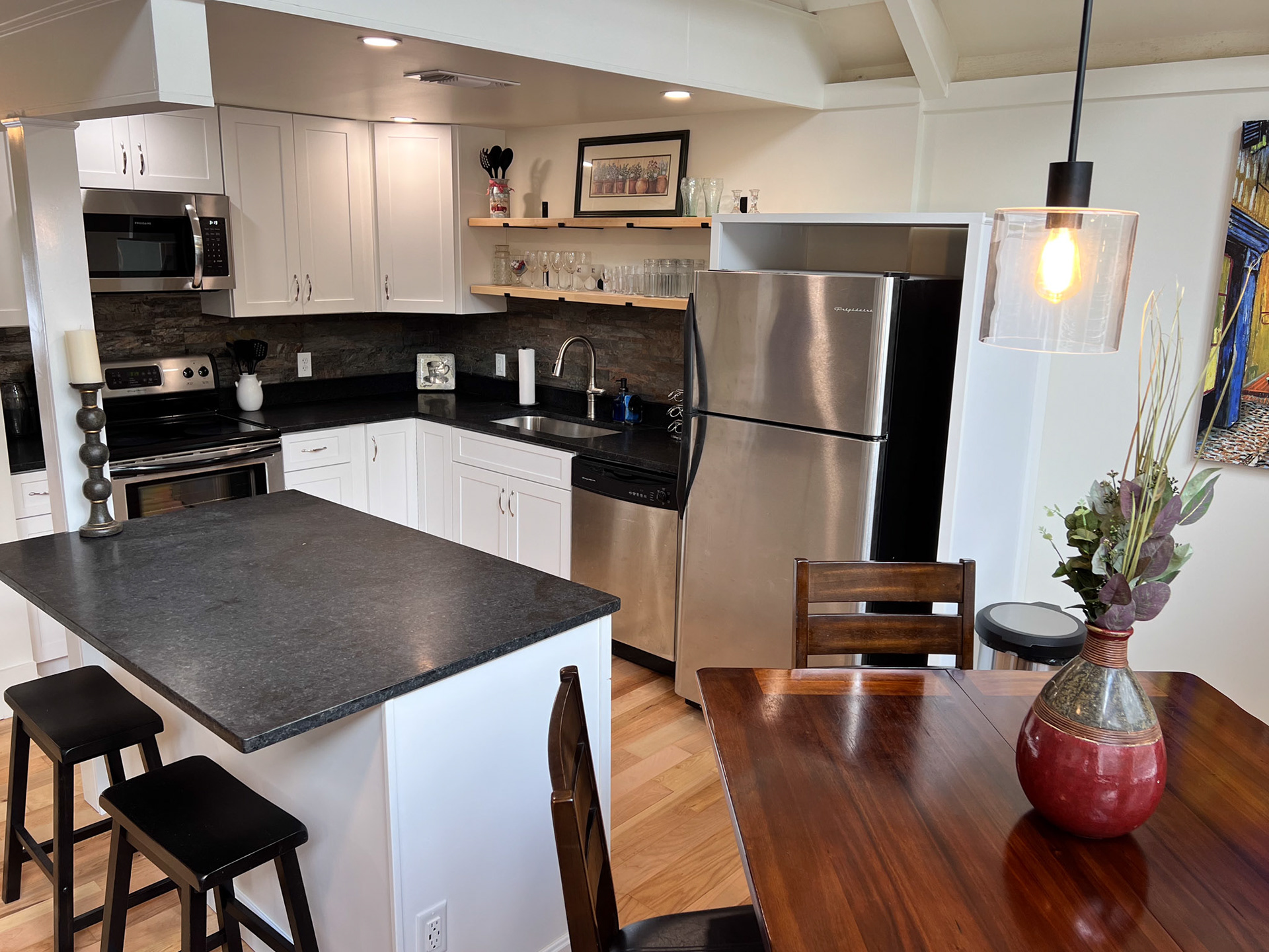 The new kitchen added new cabinets, a bar, new appliances and lights.