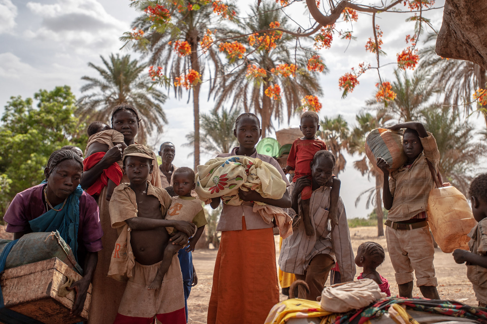 A Sudanese family fleeing government bombardments and attacks, take a break under a tree in Buram, a village in the South Cordovan province of the Nuba Mountains region in Sudan, during their several weeks's journey by foot towards Yida refugee camp, across the border in South Sudan.