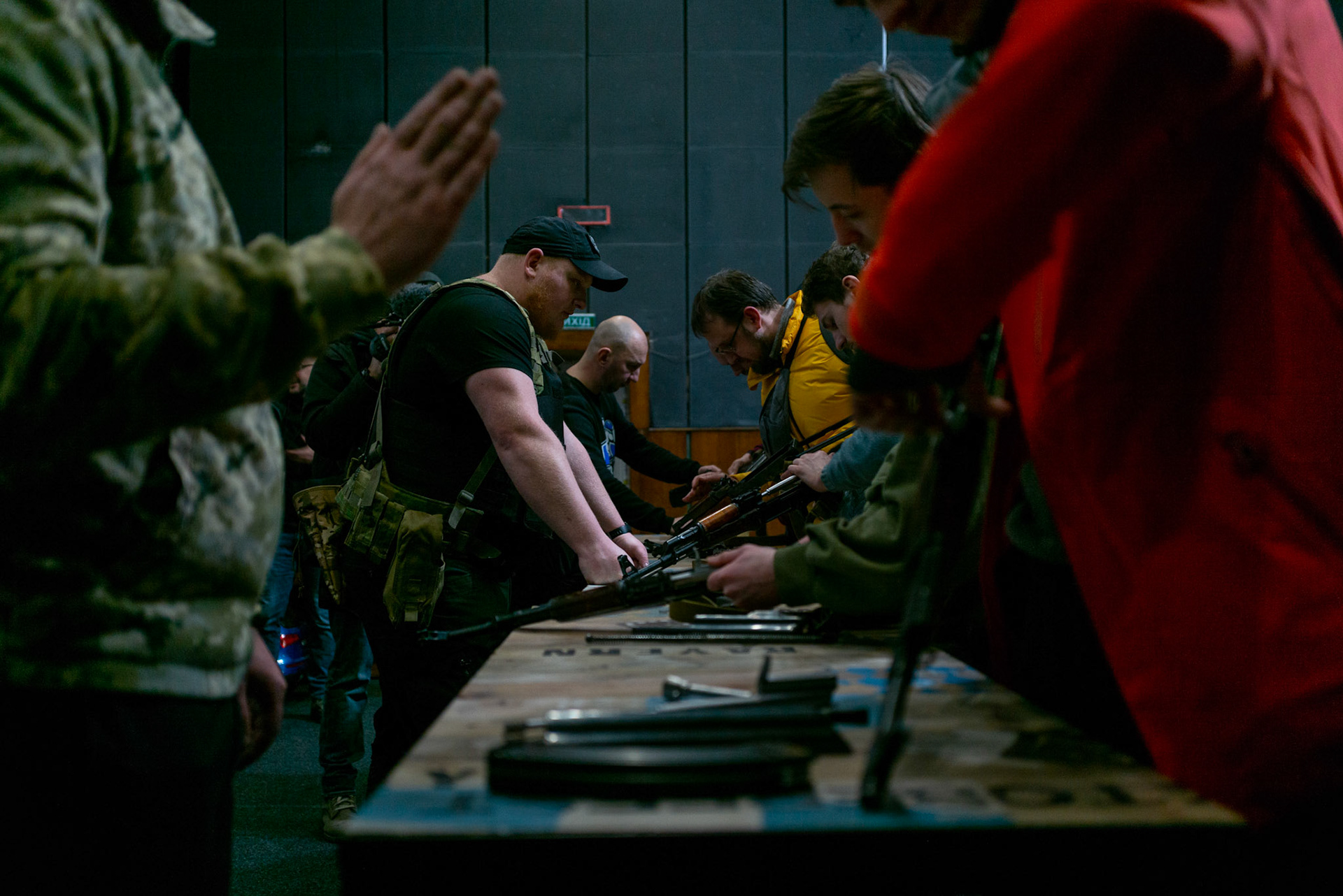 Civilian men and women receive a crash course in weapon handling at a theatre in central Lviv, as they get ready to join volunteer units to defende the city from a possible advance by the Russian troops.