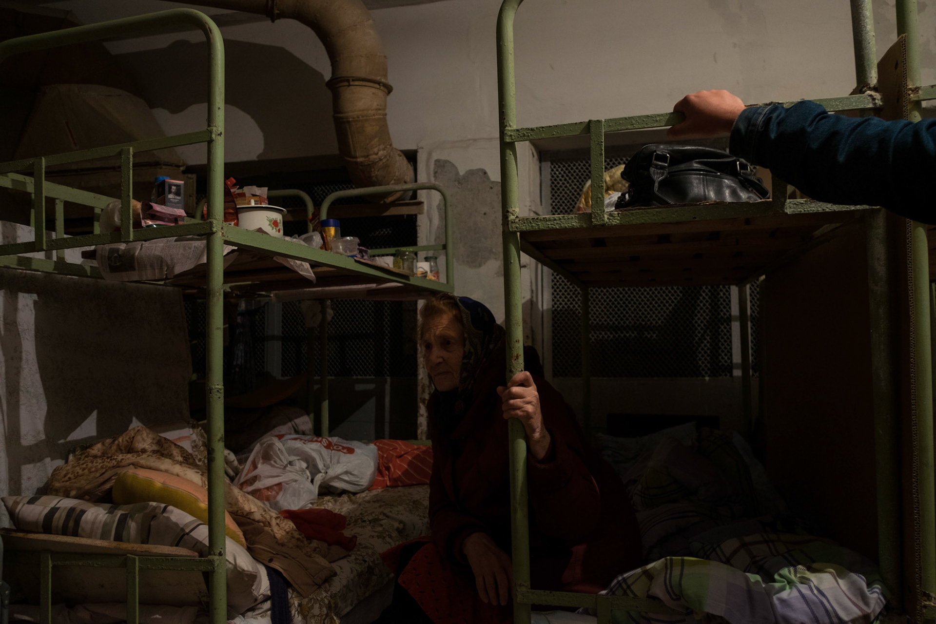 An elderly woman takes shelter in the basement of a former factory in Donetsk.