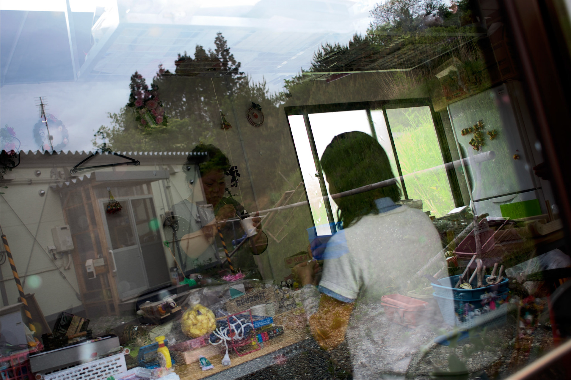 Displaced women work in a newly created arts and crafts business, run by a cooperative of residents in Togura village. The workshop is situated among prefabricated houses used as temporary shelter for families who lost their homes during the devastating earthquake and tsunami that hit the east coast of Japan in 2011. On the third anniversary of the disaster, nearly 270,000 remain displaced.