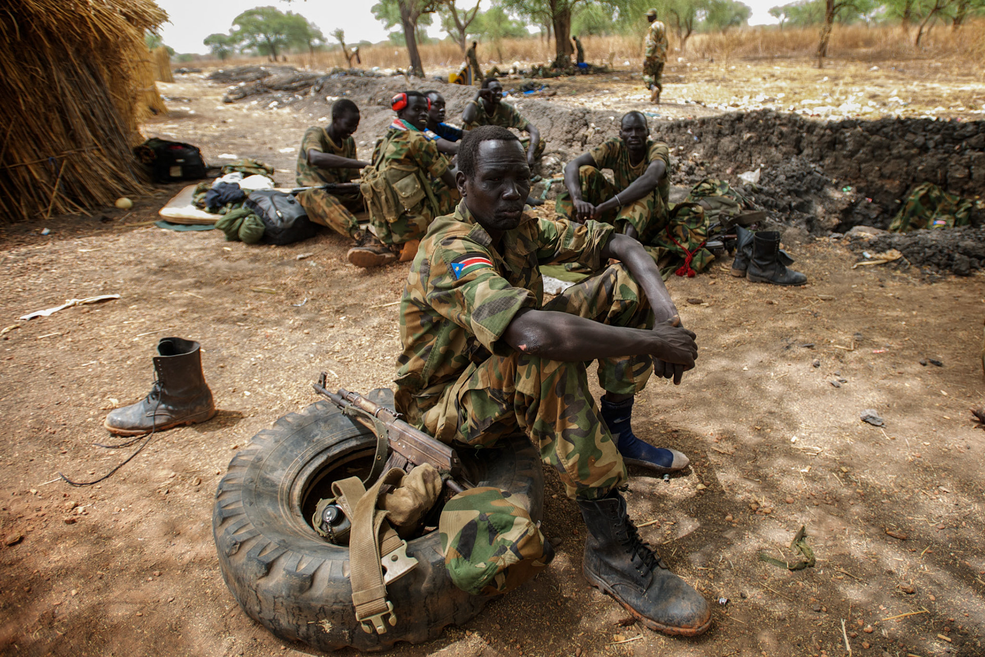 April 24, 2012 - Lalop, South Sudan: A group of SPLA soldiers rest at the newly established military base in the village o Lalop, 50 kilometers north of Bentiu...South Sudan and their northern neighbors, Sudan, have in the past two weeks been involved in heavily clashes over border disputes. Bentiu and neighboring villages have been under constant bombardment by the troops os Karthoum , who established their positions around 10 kilometers into South Sudan's territory. The international community is concerned about the possibility of a full on war between the two countries.
