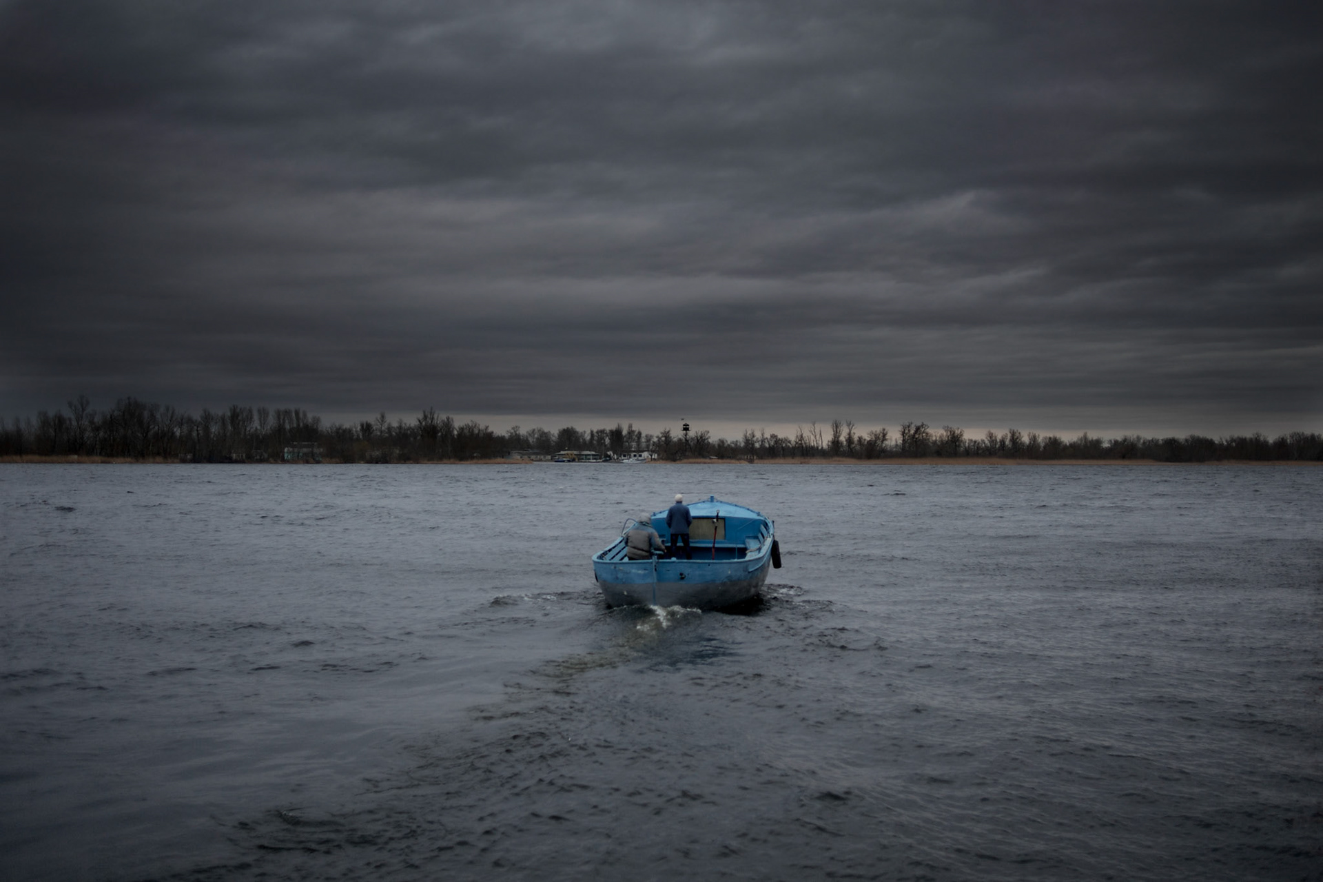 Locals cross the Dnieper river by boat in Kherson, a region bordering Crimea.