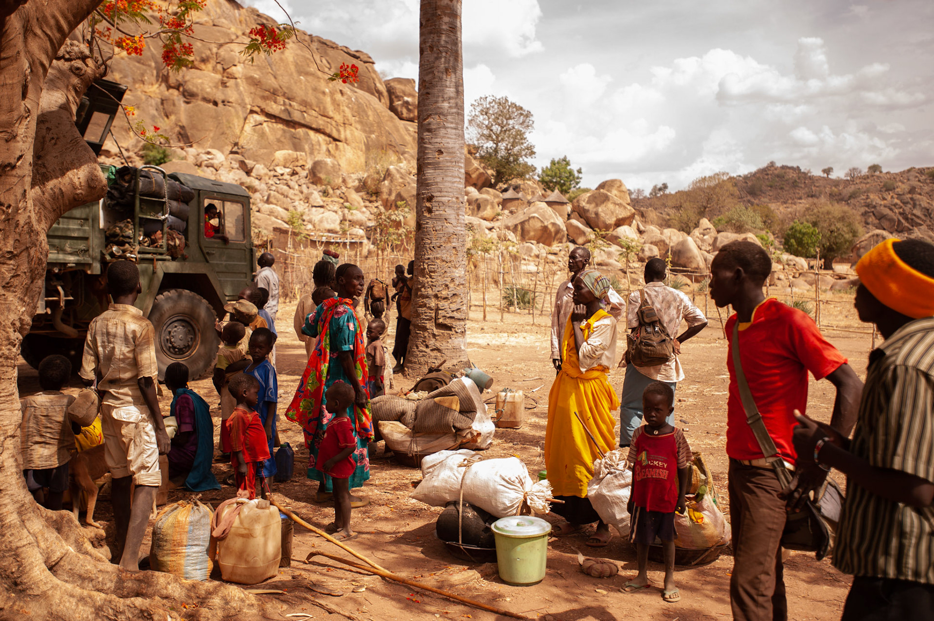 Sudanese people fleeing government bombardments and attacks, take a break under a tree in Buram, a village in the South Cordovan province of the Nuba Mountains region in Sudan, during their several weeks's journey by foot towards Yida refugee camp, across the border in South Sudan.