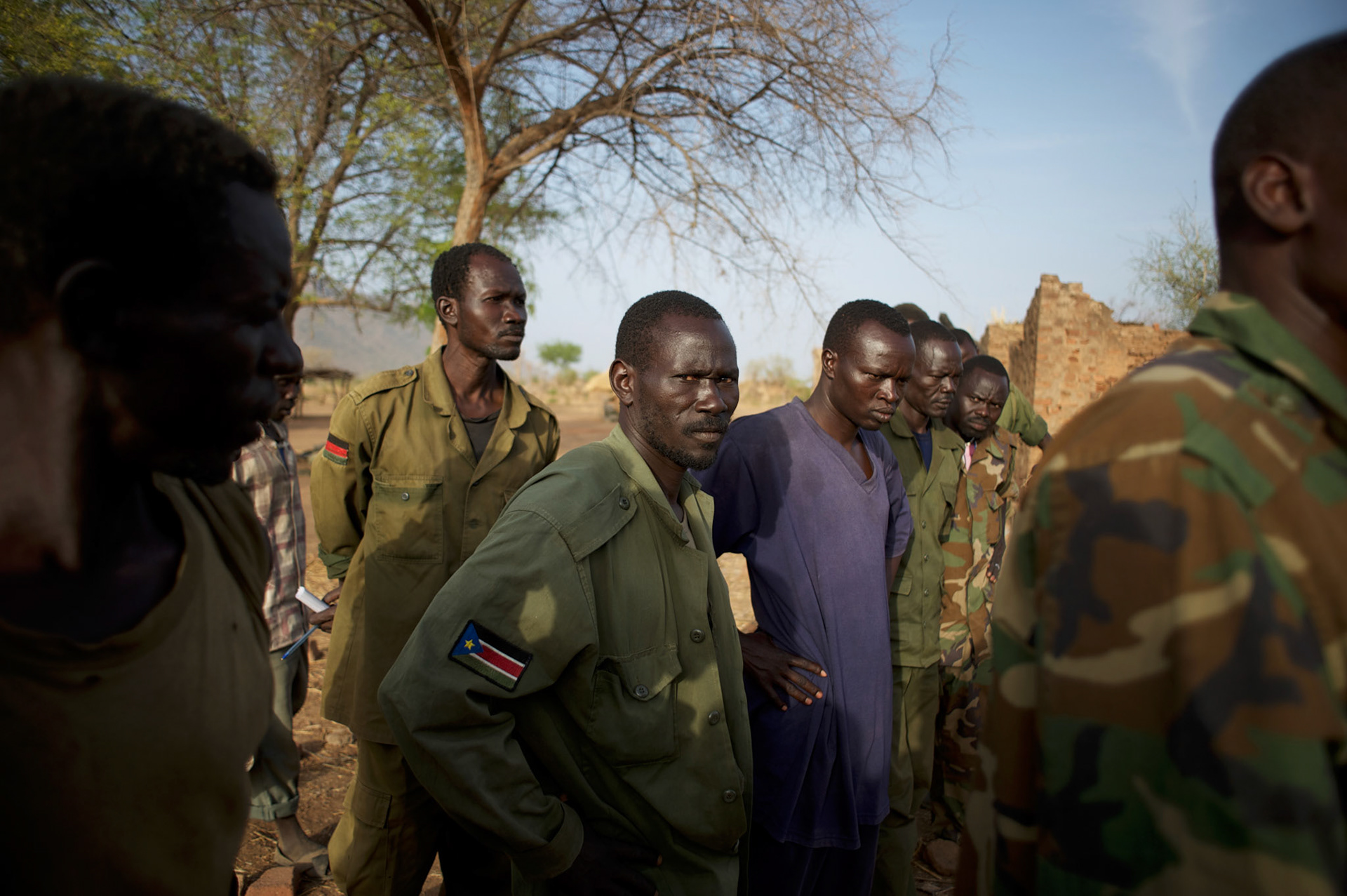 A group of Sudan People's Liberation Movement (SPLA-N) rebel fighters look at weapons and ammunition captured from Sudan's Armed Forces (SAF) during recent combats in the rebel-held territory of the Nuba Mountains in South Kordofan.