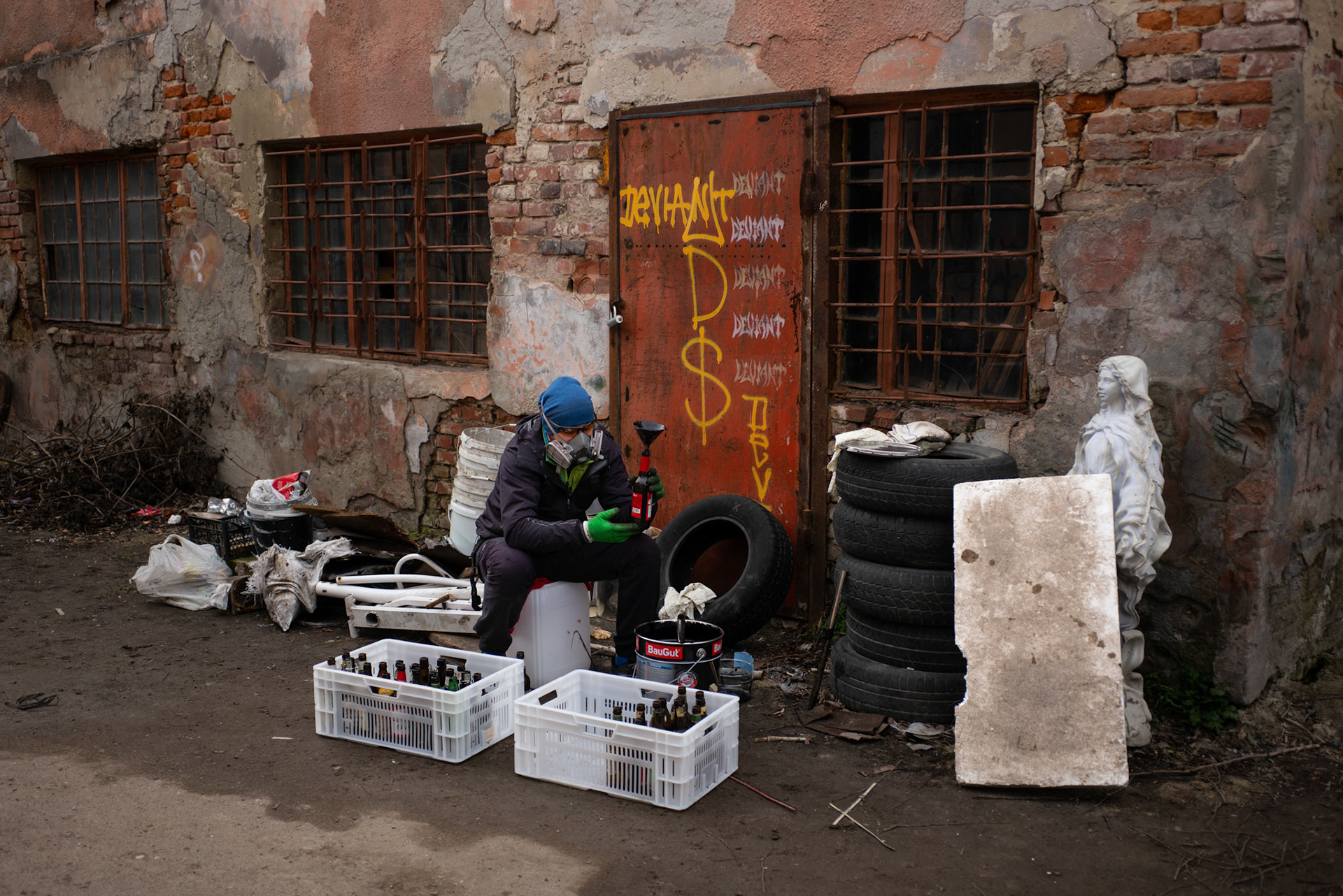 A masked volunteer prepares petrol bombs – commonly known as cocktail Molotovs – to be sent to other cities and frontlines around the country, at a makeshift factory in an undisclosed location in central Lviv.