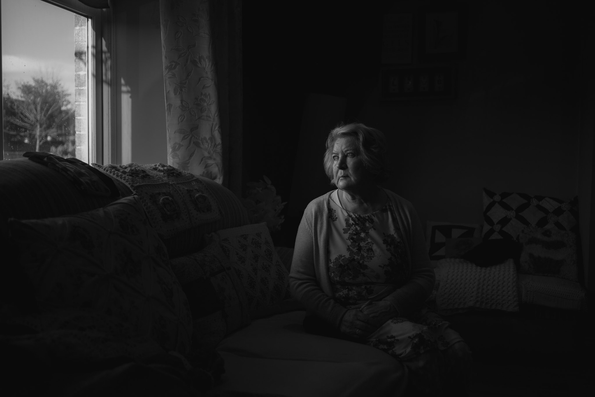 TUAM, IRELAND - OCTOBER 26, 2022: Carmel Larkin, one of the many "home babies" who spent her early years at St. Mary’s Mother and Baby Home,poses for a portrait in her home in Tuam, Ireland, on October 26, 2022. In 2014, Catherine Corless, a local historian, went public with information concerning the deaths of 798 children at St. Mary’s Mother and Baby Home, a maternity home for unmarried mothers and their children run by the Bon Secours order in Tuam. Corless' research led her to conclude that almost all had been buried in an unmarked and unregistered site at the Home. Subsequent excavations carried out by an Irish government appointed Commission, found a significant quantity of human remains in a vault with twenty chambers, believed to be part of an old septic tank from the period the site was use as a workhouse. CREDIT: Paulo Nunes dos Santos for The New York Times