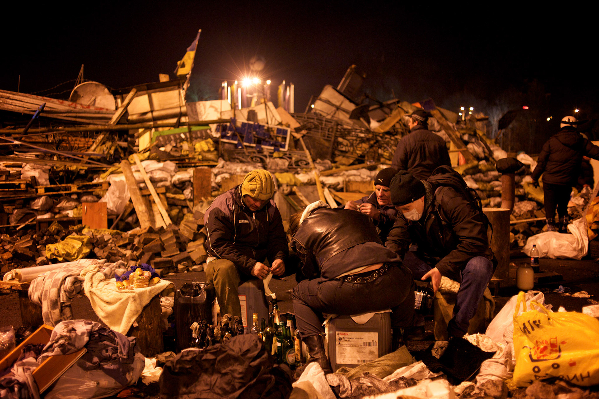 KIEV, UKRAINE - February 20, 2014: Anti-government protestors prepare petrol bombs near a barricade in Maidan, hours after violent clashes between protestors and riot police happened outside Independence Square in central Kiev. The riot police responded to the advance with gunfire that, according to the opposition, killed at least 70 and as many as 100 people. The drastic escalation of the three-month-old Ukraine crisis left the country reeling from the most lethal violence in decades. CREDIT: Paulo Nunes dos Santos