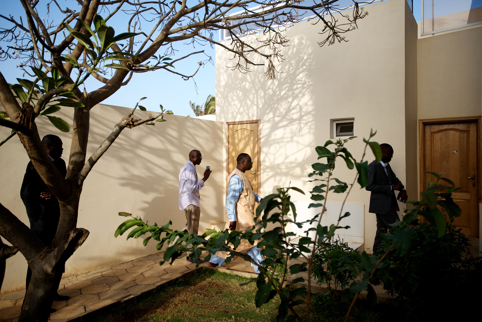 February 28, 2012 - Dakar, Senegal: Senegalese presidential candidate Macky Sall walks by accompanied by his campaign staff at his house in central Dakar. According to the provisory results of last Sunday's presidential election, Macky will most likely be running against the former president and candidate Abdoulaye Wade in a second round of the elections. (Paulo Nunes dos Santos/Polaris)