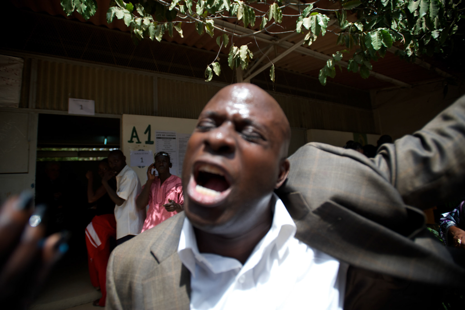 February 26, 2012 - Dakar, Senegal: A senegalese man shouts insults against the president and candidate, Abdoulaye Wade, while votingat the Franco-Arab School in Point E area of Dakar. Hundreds of people queueing for voting insulted and heckled Wade, accusing the head of state of disrespect for the country's constitution when running for a third mandate. (Paulo Nunes dos Santos/Polaris)