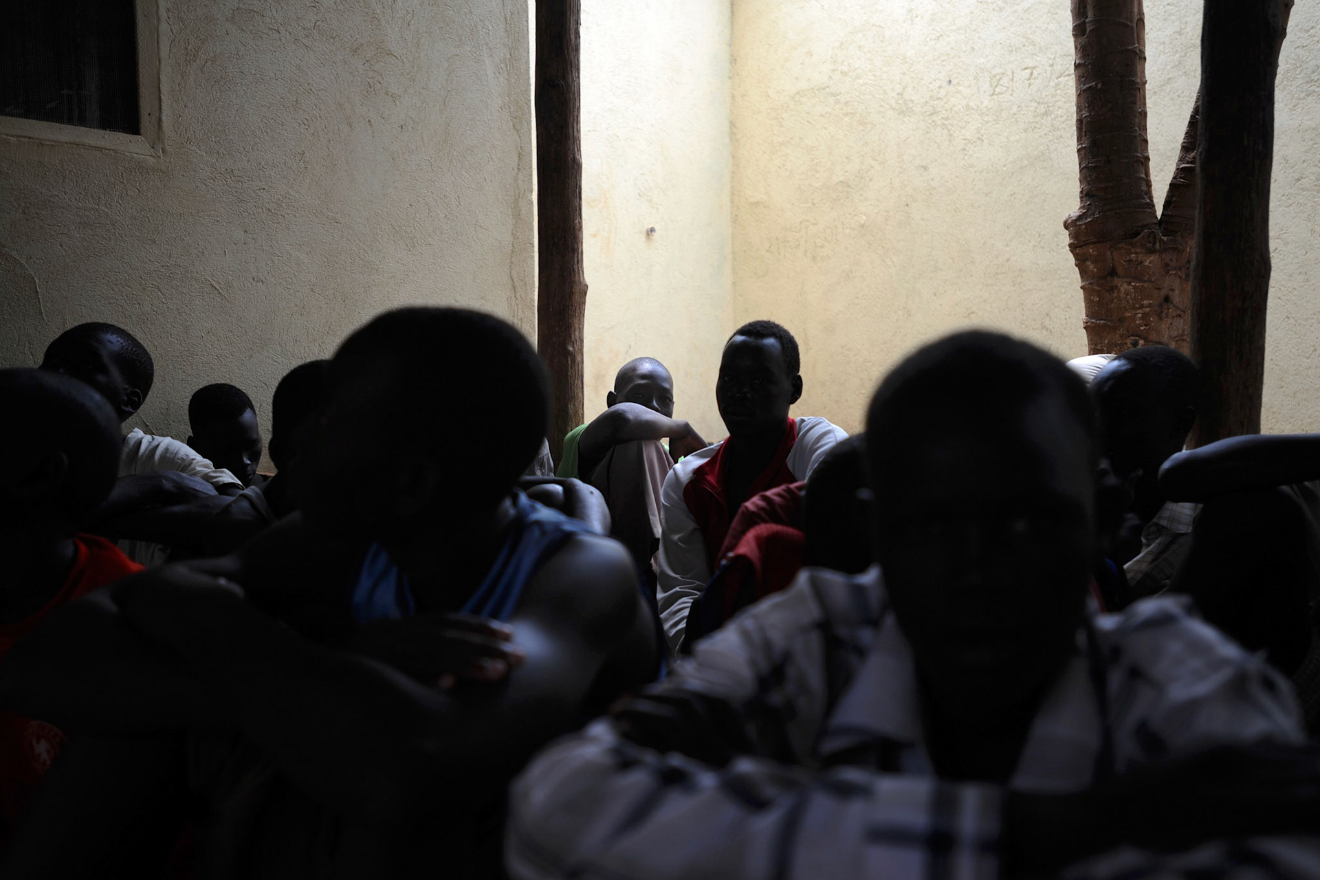 A group of child inmates gather in the juvenil patio area  of Juba Central Prison. The prison accommodates dozens of inmates with ages between fourteen and eighteen years old, many charged with murder and theft.