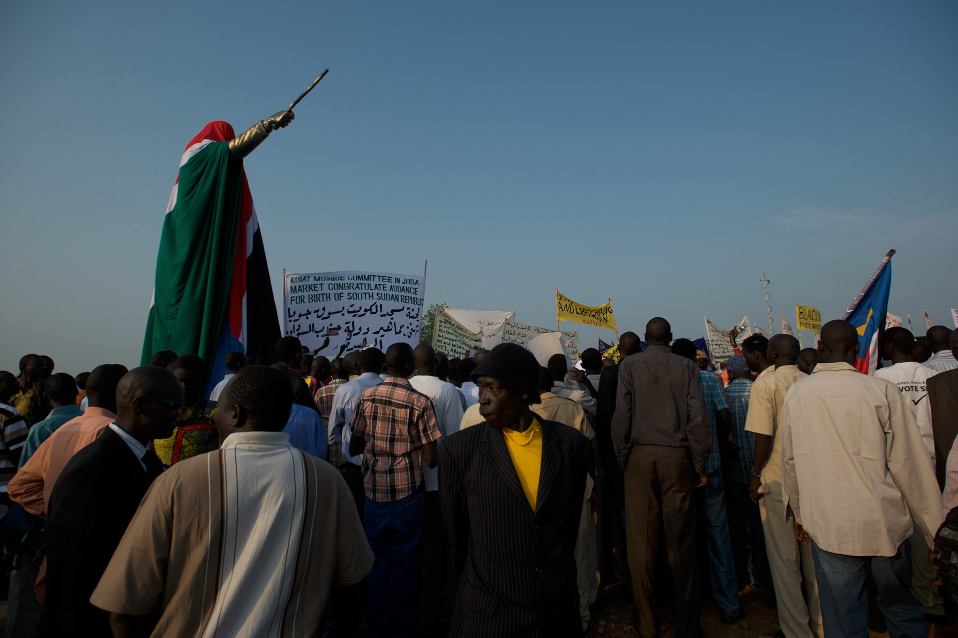 A crowd gathers around the unveiled statue of John Garang de Mabior, the historical leader of Sudan People's Liberation Army (SPLA) during the second sudanese civil war, ahead of the official ceremony marking South Sudan as an independent nation.