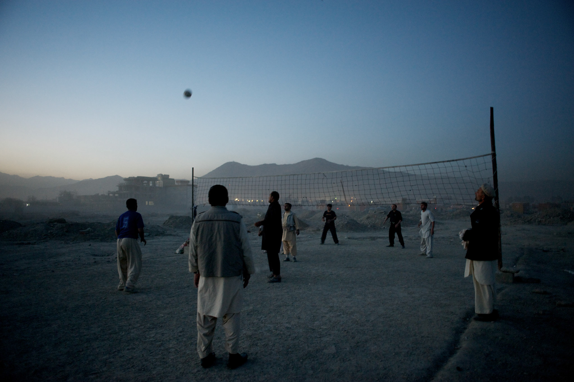 November 14, 2012 - Kabul, Afghanistan: Local afghan men play volleyball beside a garbage dump site in the outskirts of Kabul. (Paulo Nunes dos Santos)