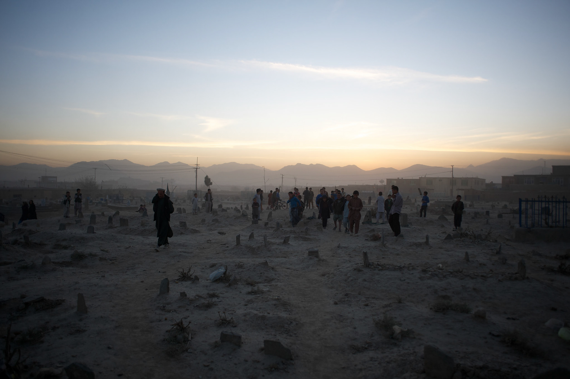 November 08, 2012 - Kabul, Afghanistan: Children play in a cemetery at sunset in the outskirts of Kabul. (Paulo Nunes dos Santos)