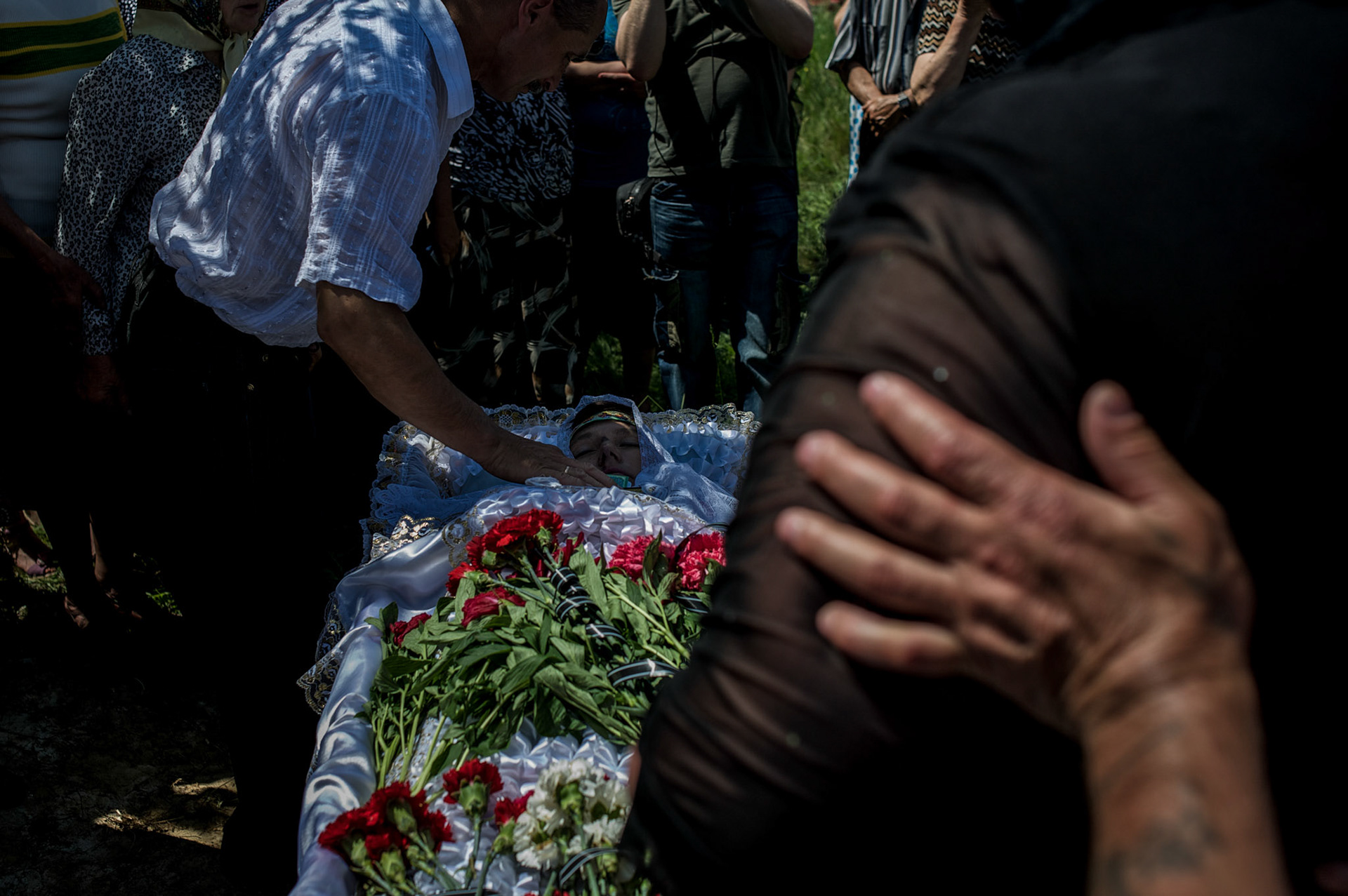 The funeral of Elena Ott, a 42 year old woman shot dead by the army near Starovarvarovka.