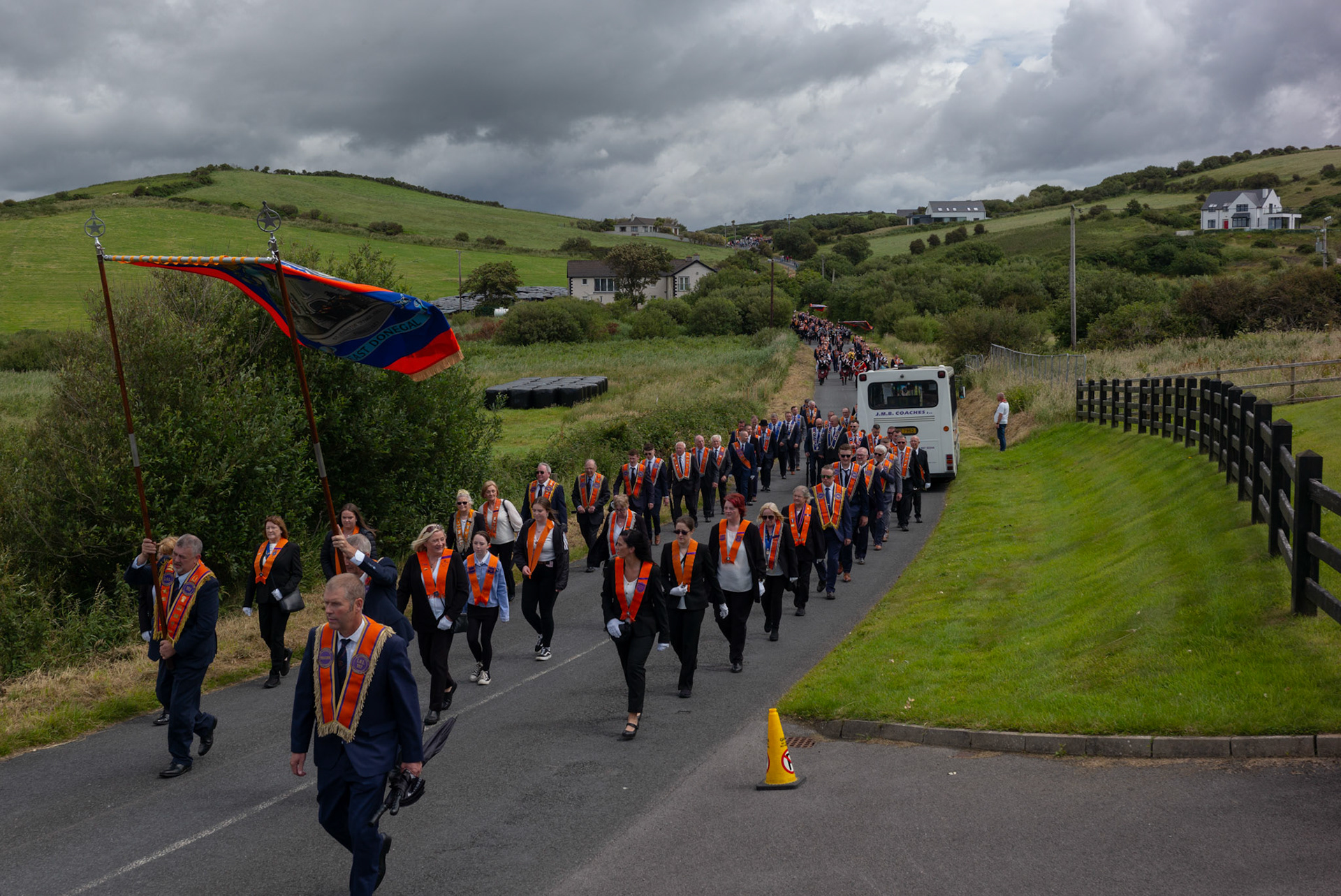 Orange lodges march down a country road during the annual Orange Order parade at Rossnowlagh Beach in Co. Donegal, Ireland, on July 6, 2024. Around 50 Orange lodges from Ireland and Northern Ireland paraded down a country lane toward the seaside village of Rossnowlagh on Saturday, the only annual Orange Order parade in the Republic of Ireland. Thousands attended the parade, which traditionally takes place on the Saturday before the main Twelfth demonstrations in Northern Ireland.