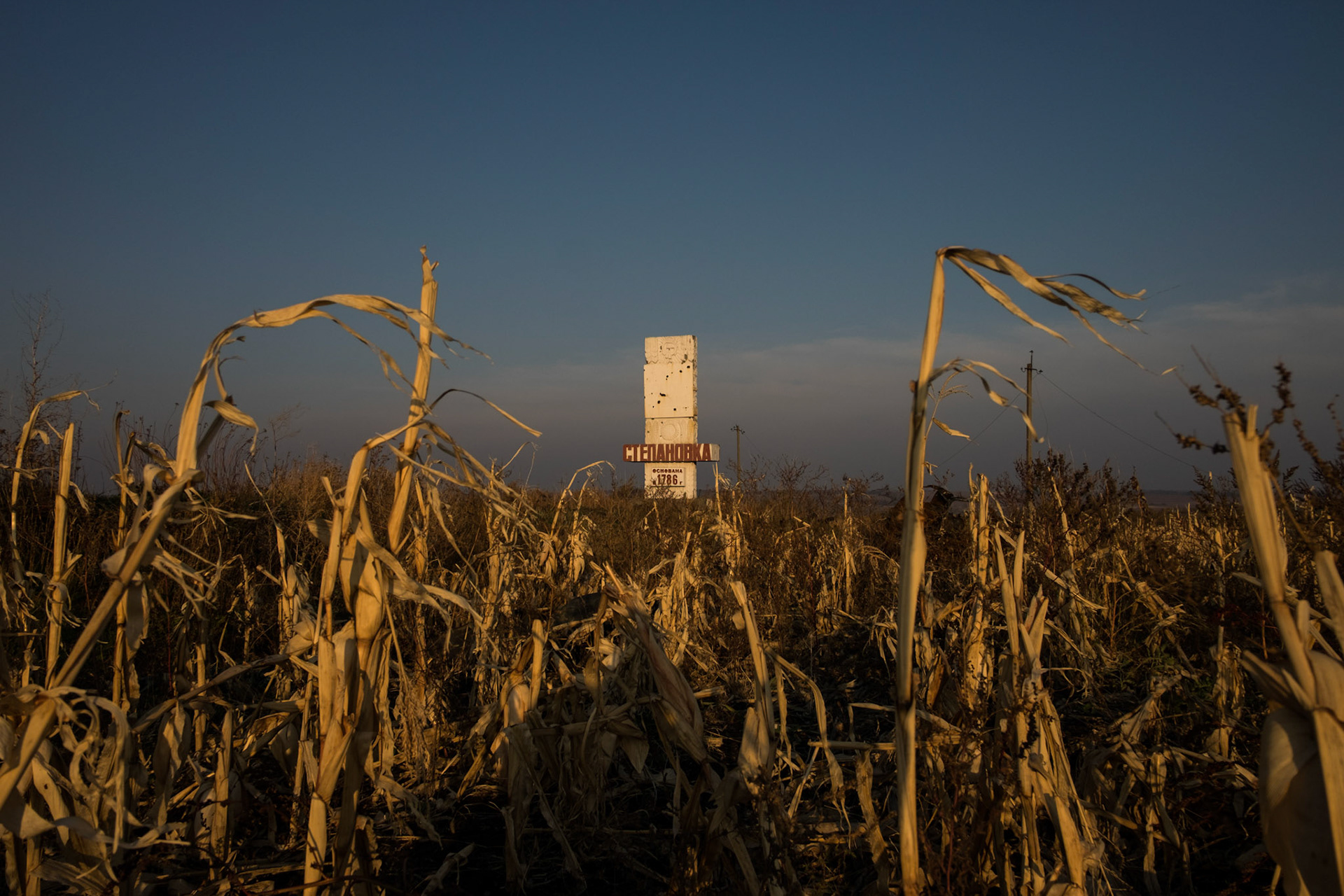 The sun sets over a crop field used as a battlefield near Petrovskiy, a small village close to the Russian border.