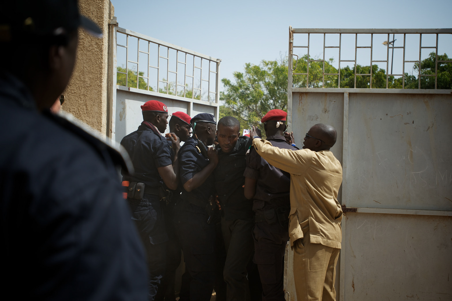 February 26, 2012 - Dakar, Senegal: Senegalese police try to control a crowd who tried to attack president and candidate, Abdoulaye Wade, while voting at the Franco-Arab School in Point E area of Dakar. Hundreds of people queueing for voting insulted and heckled Wade, accusing the head of state of disrespect for the country's constitution when running for a third mandate. (Paulo Nunes dos Santos/Polaris)