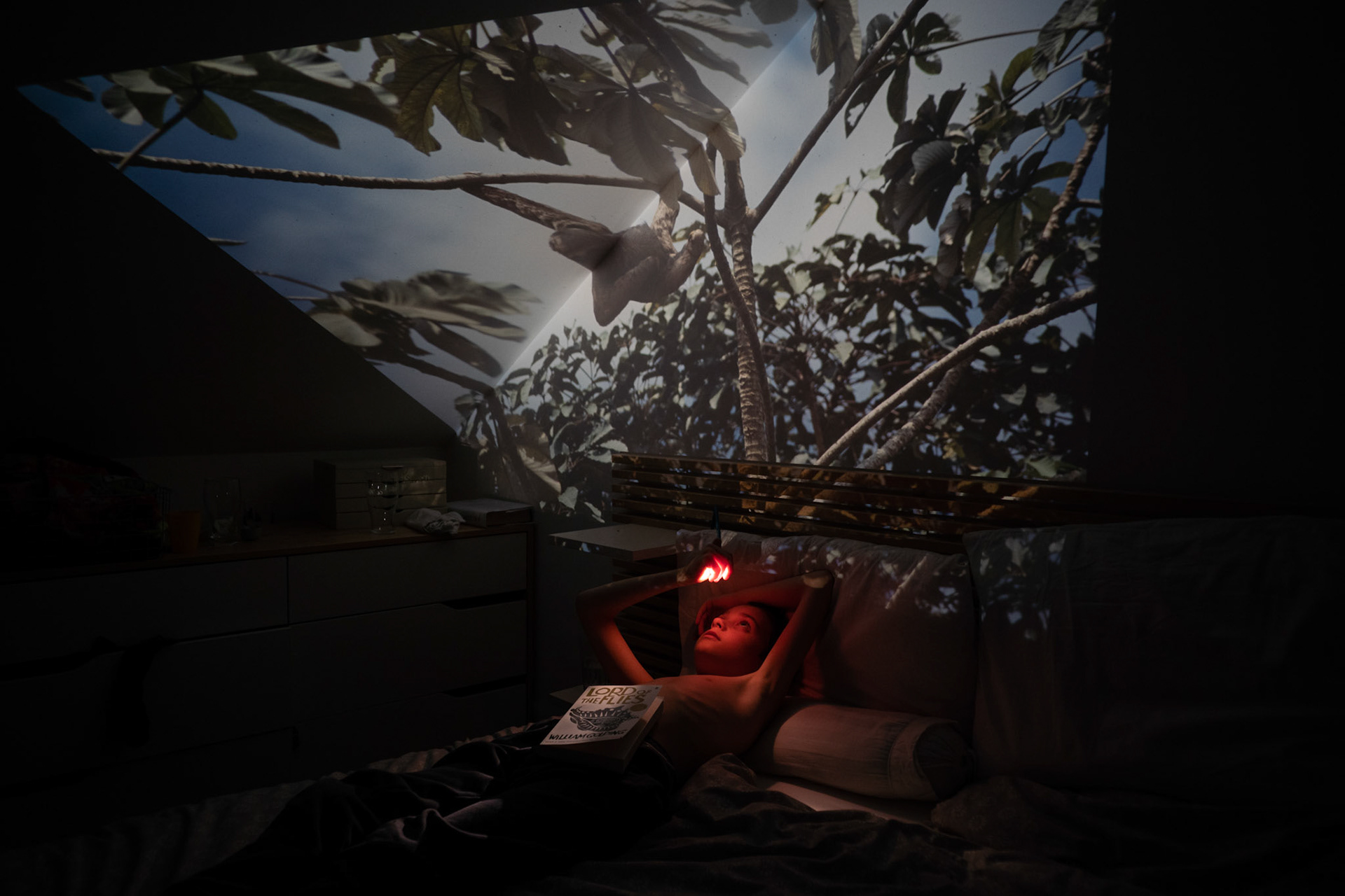 Oliver gazing at an image from Santa Cruz del Campo projected onto the attic bedroom ceiling.