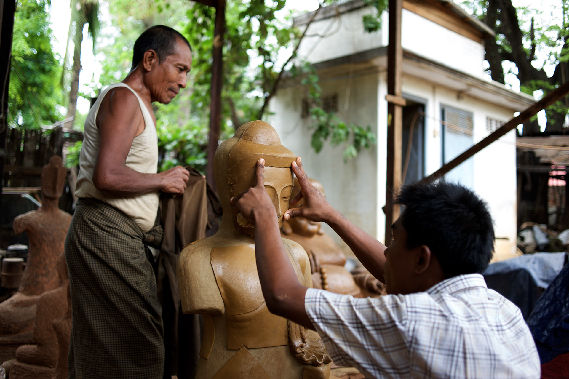May 14, 2013 - Mandalay, Myanmar: A local worker makes the mould for a buddha copper statue at a traditional workshop in Mandalay. CREDIT: Paulo Nunes dos Santos