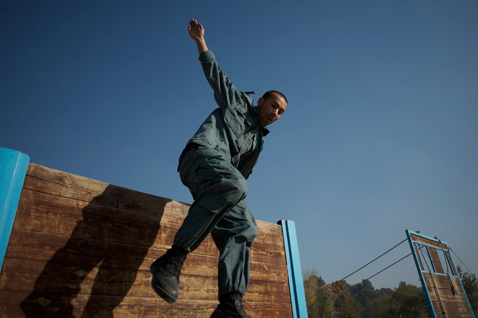 An Afghan National Police (ANP) cadet jumps an obstacle during morning endurance exercises at the Afghan Nacional Police Academy in Kabul.