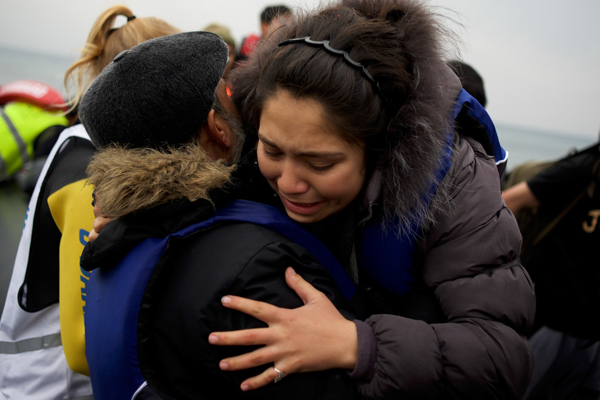 A migrant woman react as she arrives on the shores of a beach in the outskirts of Mytilene in Lesbos island, Greece.