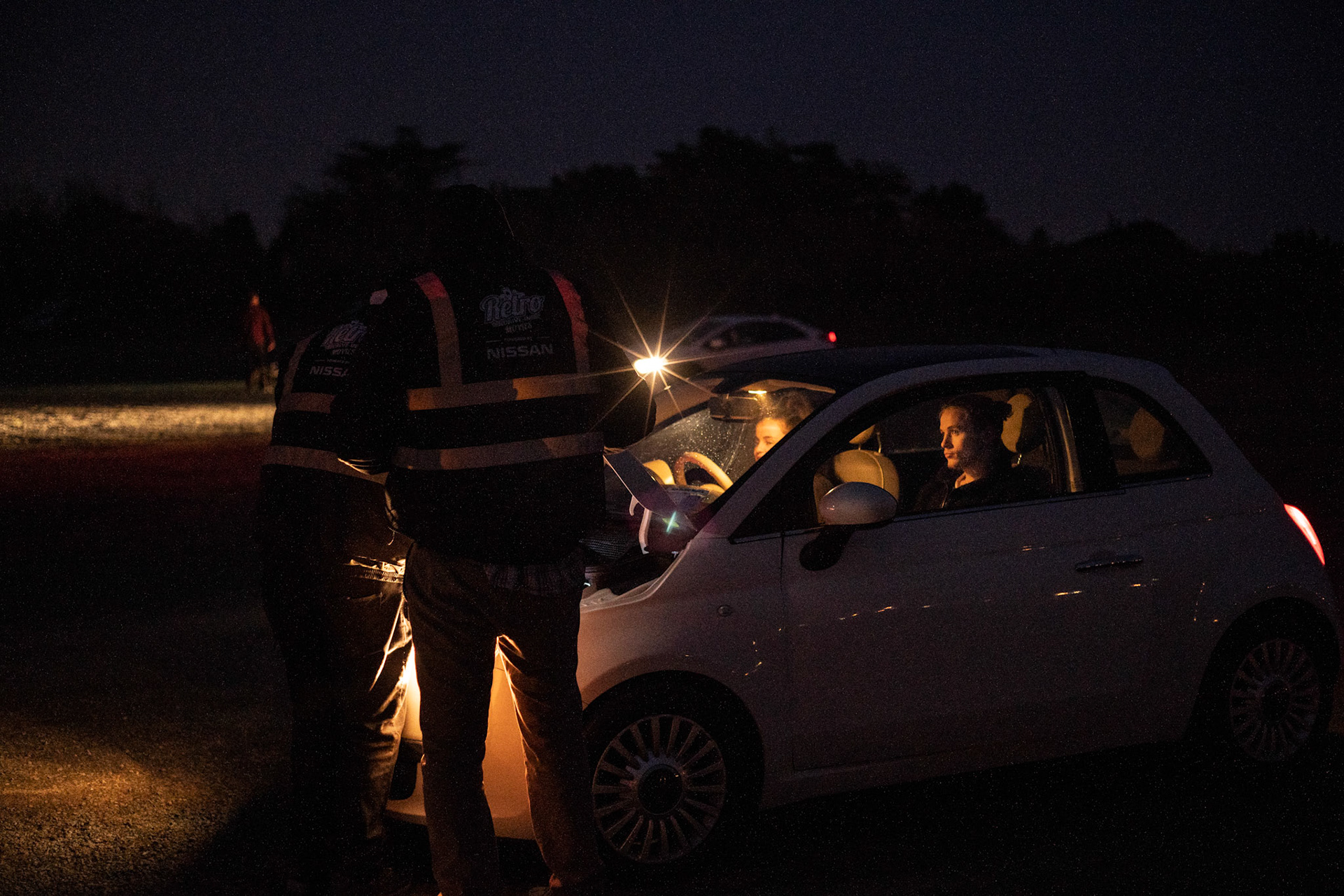 As a screening end, staff helps to jump- start a couple’s car low on battery. A common occurrence for which they are prepared. Dublin, Ireland - March 23, 2020.