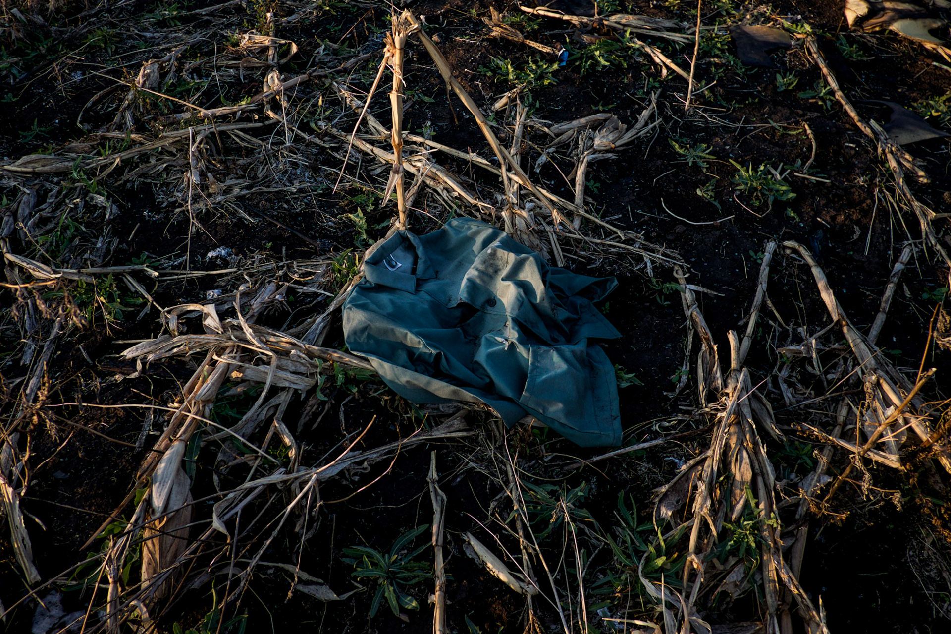 A military uniform lays among destroyed crops days after a battle near Petrovskiy.