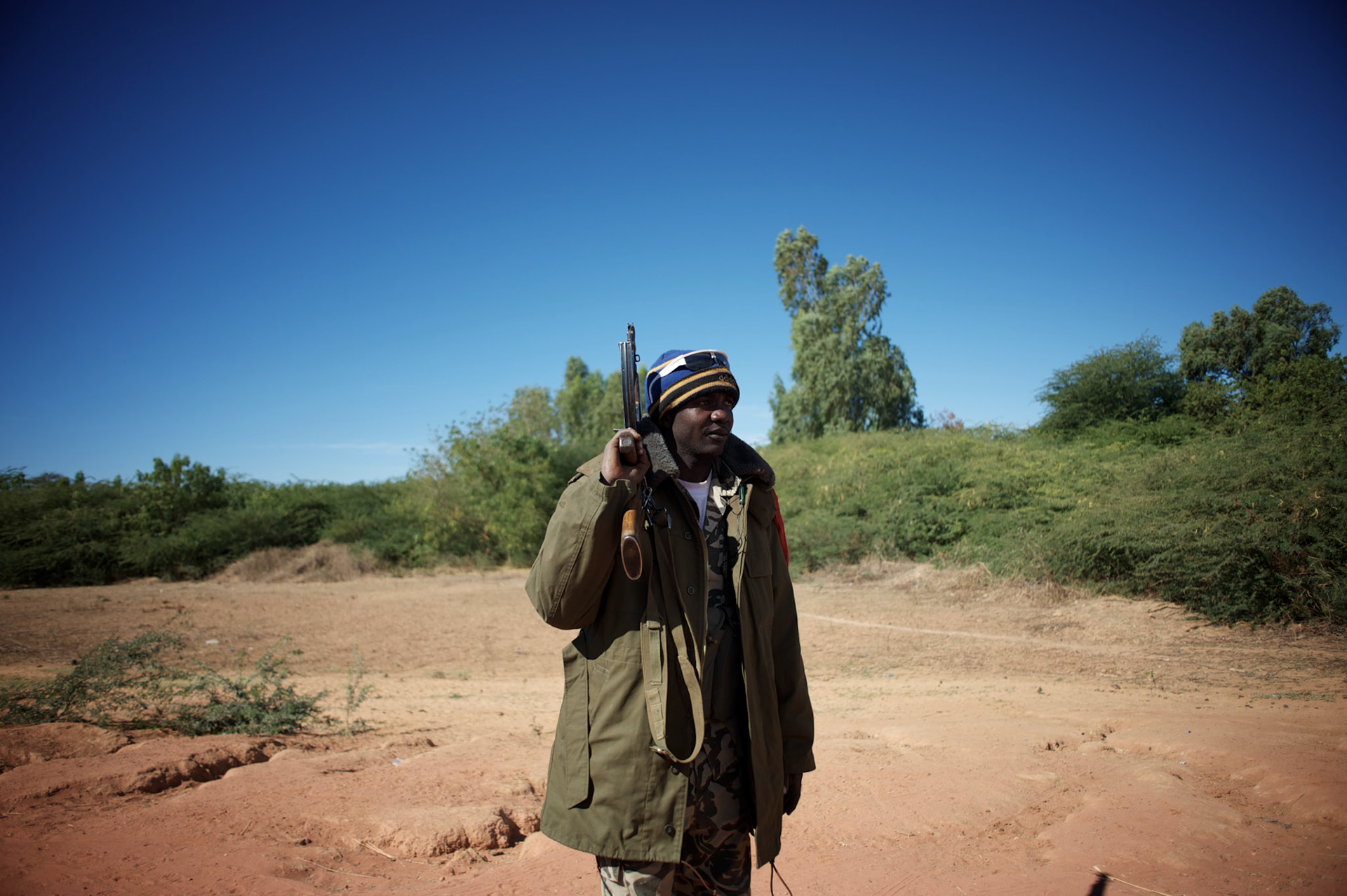 January 21, 2013 - Diabaly, Mali: A Mali army man takes guard on the road outside Diabaly, a day after the government troops regain control of the city. Diabaly was under islamist militants control since the 14th of January.Several insurgent groups have been fighting a campaign against the Malian government for independence or greater autonomy for northern Mali, an area known as Azawad. The National Movement for the Liberation of Azawad (MNLA), an organisation fighting to make Azawad an independent homeland for the Tuareg people, had taken control of the region by April 2012.The Malian government pledge to the French army to help the national troops to stop the rebellion advance towards the capital Bamako. The french troops started aerial attacks on rebel positions in the centre of the country and deployed several hundred special forces men to counter attack the advance on the ground. (Paulo Nunes dos Santos)