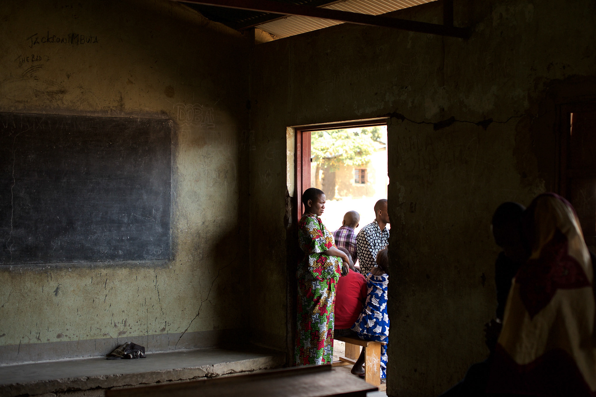 Members of Burundiís National Electoral Commission stand outside a classroom used as a poling station for the parliamentary elections in Cibitoke neighbourhood, Bujumbura, June 28th, 2015.