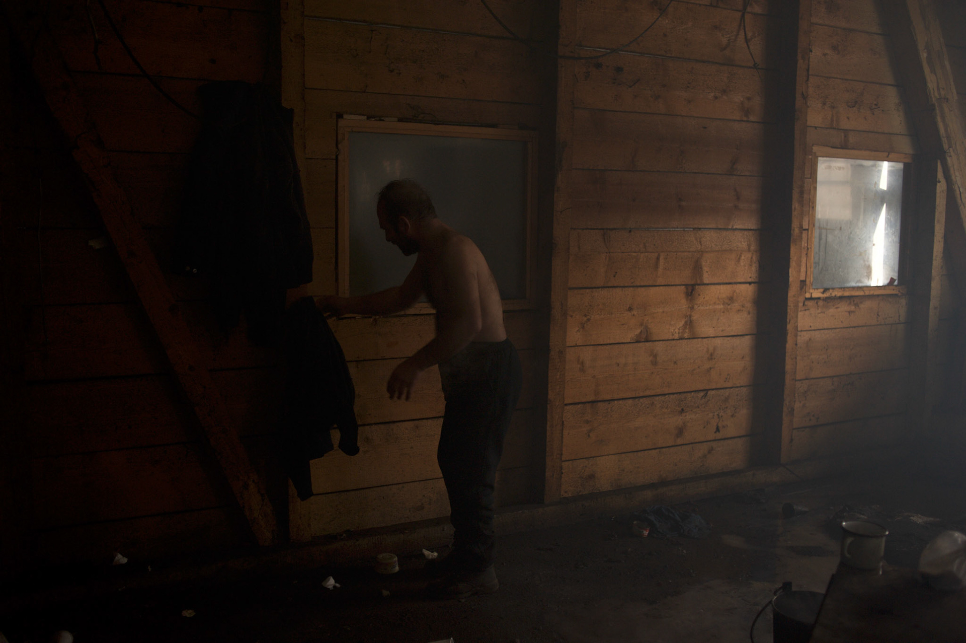 An afghan migrants washes himself inside the old warehouses near Belgrade's main railway station. The thousands of migrants living here do not have access to clean running water or shower facilities.